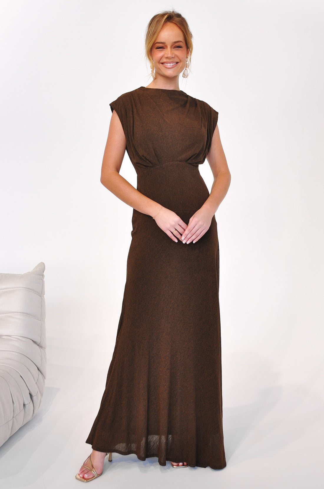 Woman wearing the Brigitte Gown, a cocoa brown maxi length event dress