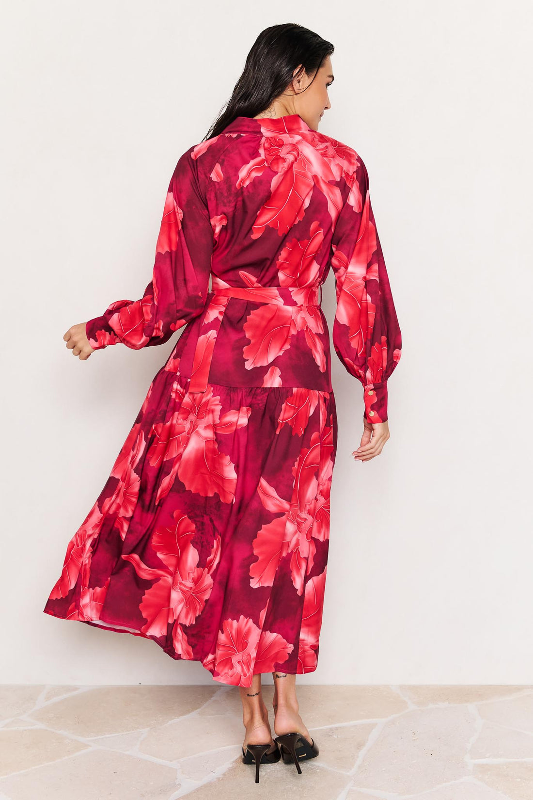 Back view of woman wearing the minnie + MAXXIE Camille red floral midi dress on a white background