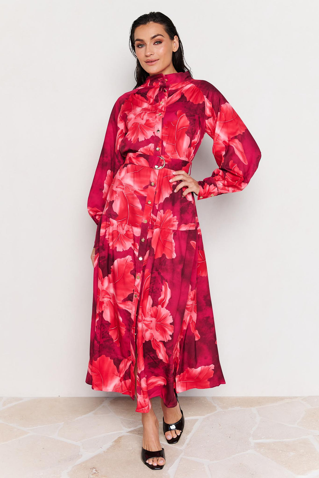 Woman wearing the minnie + MAXXIE Camille red floral midi dress on a white background