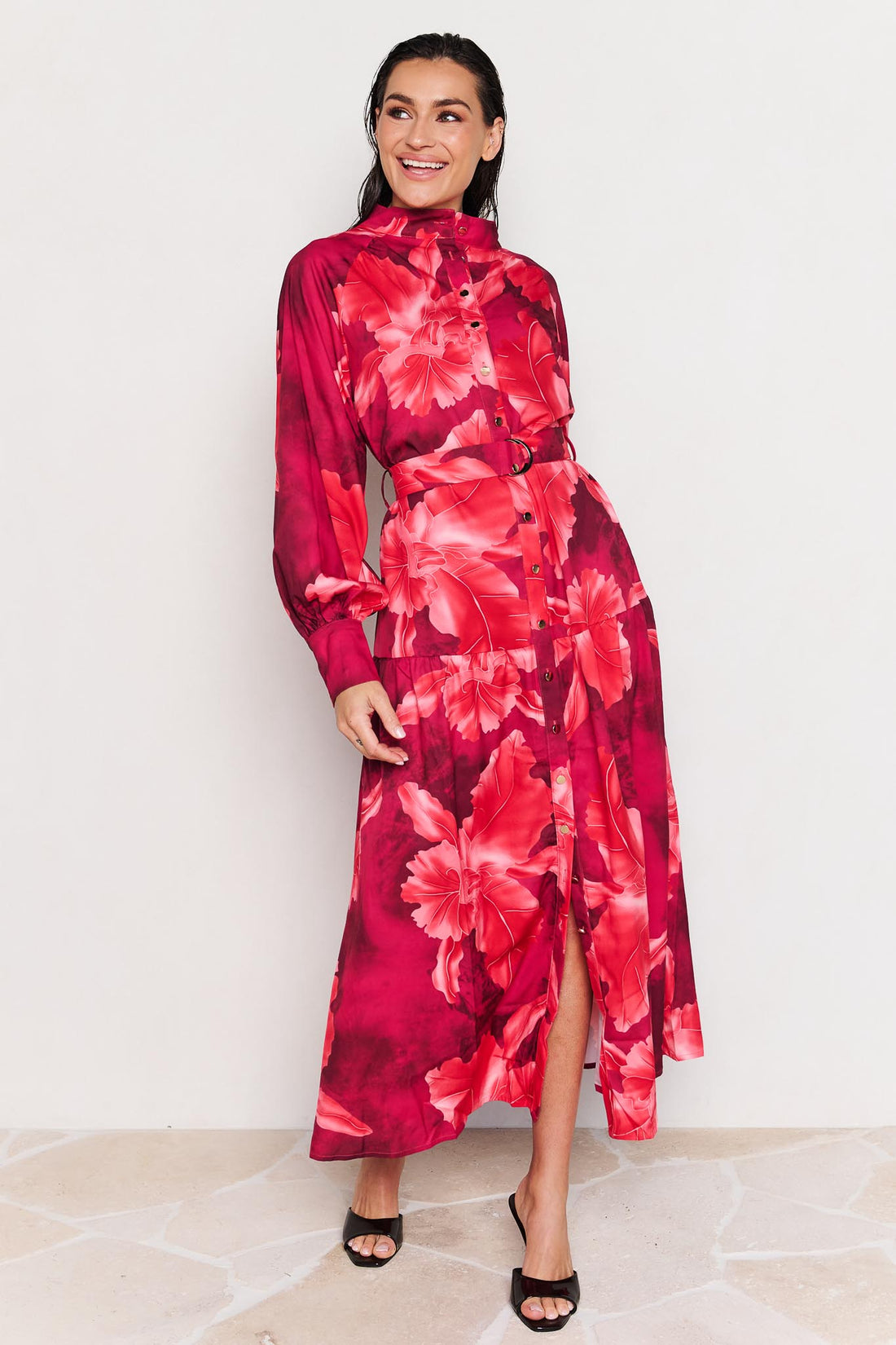 Woman wearing the minnie + MAXXIE Camille red floral midi dress on a white background