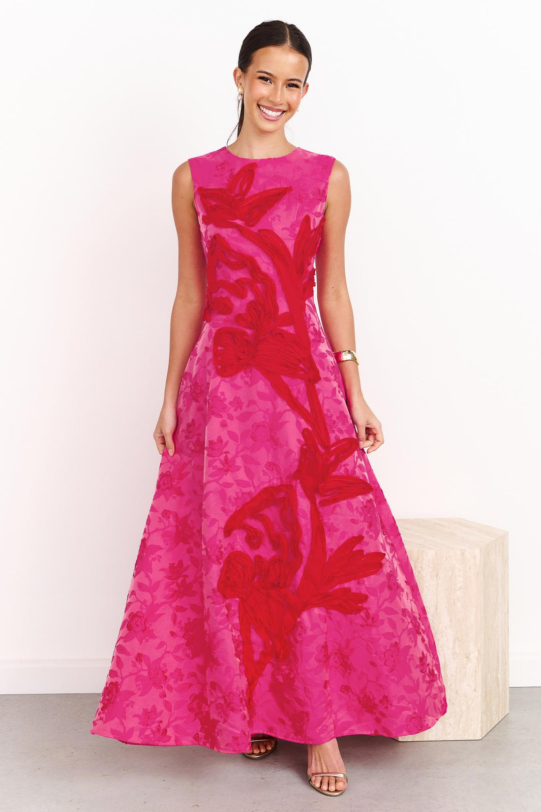 A woman wearing the ELLIATT Textured Jacquard Maxi Dress in Pink and Red
