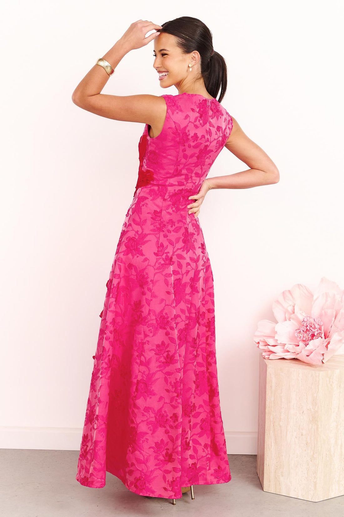 Back view of a model wearing the ELLIATT Textured Jacquard Maxi Dress in Pink and Red