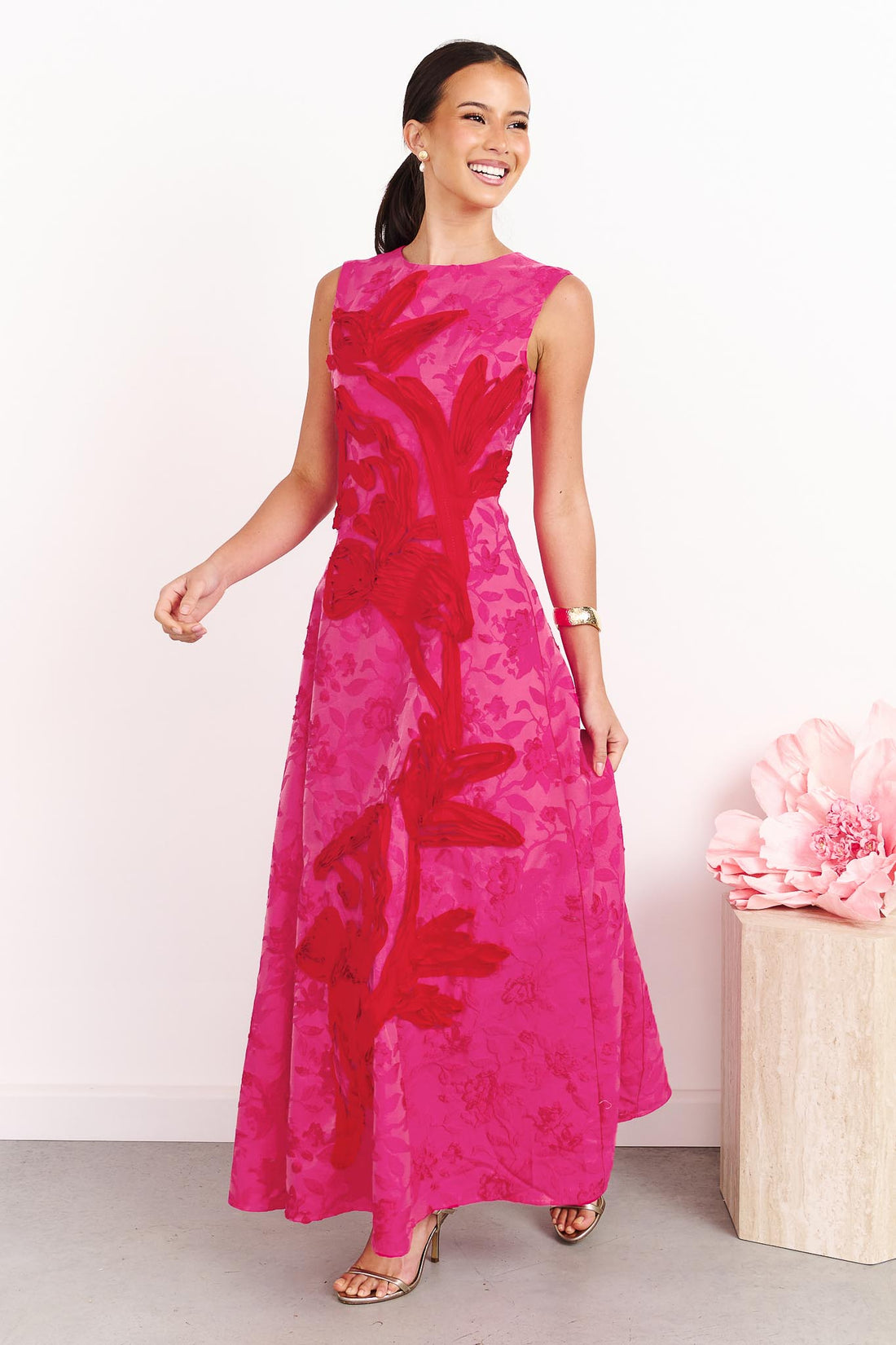 A woman wearing the ELLIATT Textured Jacquard Maxi Dress in Pink and Red