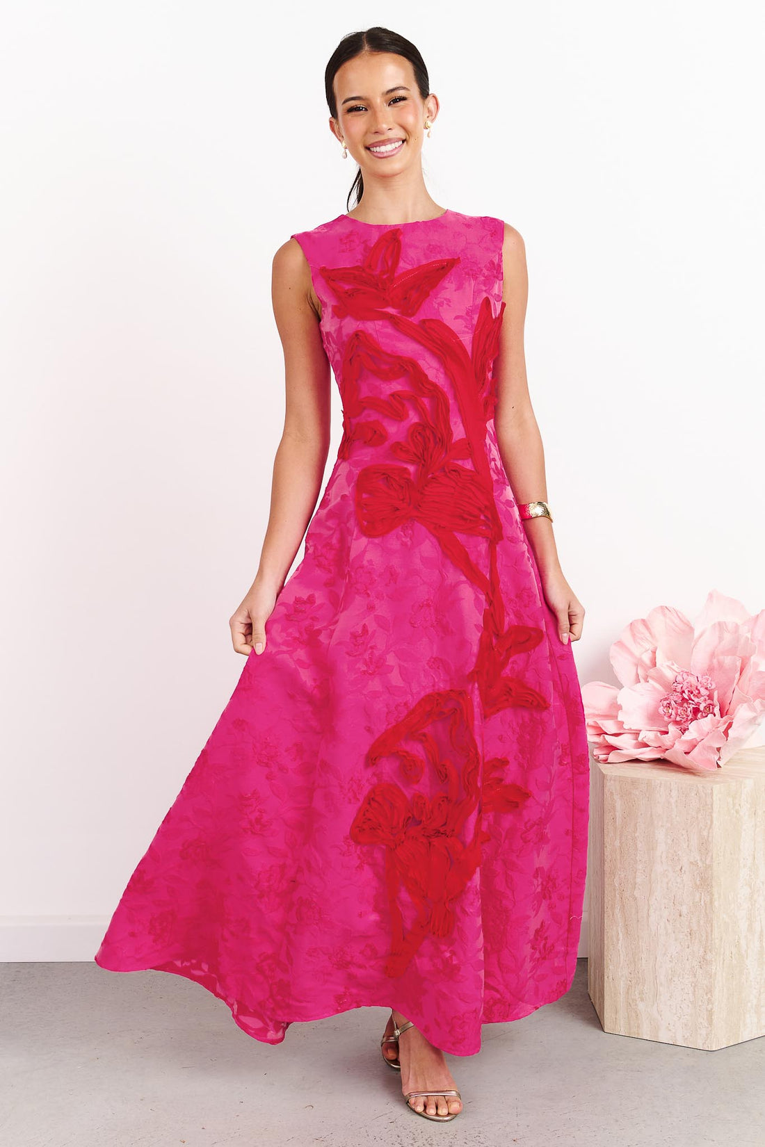 A woman wearing the ELLIATT Textured Jacquard Maxi Dress in Pink and Red