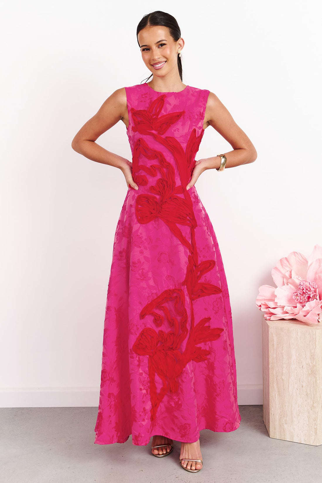 A woman wearing the ELLIATT Textured Jacquard Maxi Dress in Pink and Red