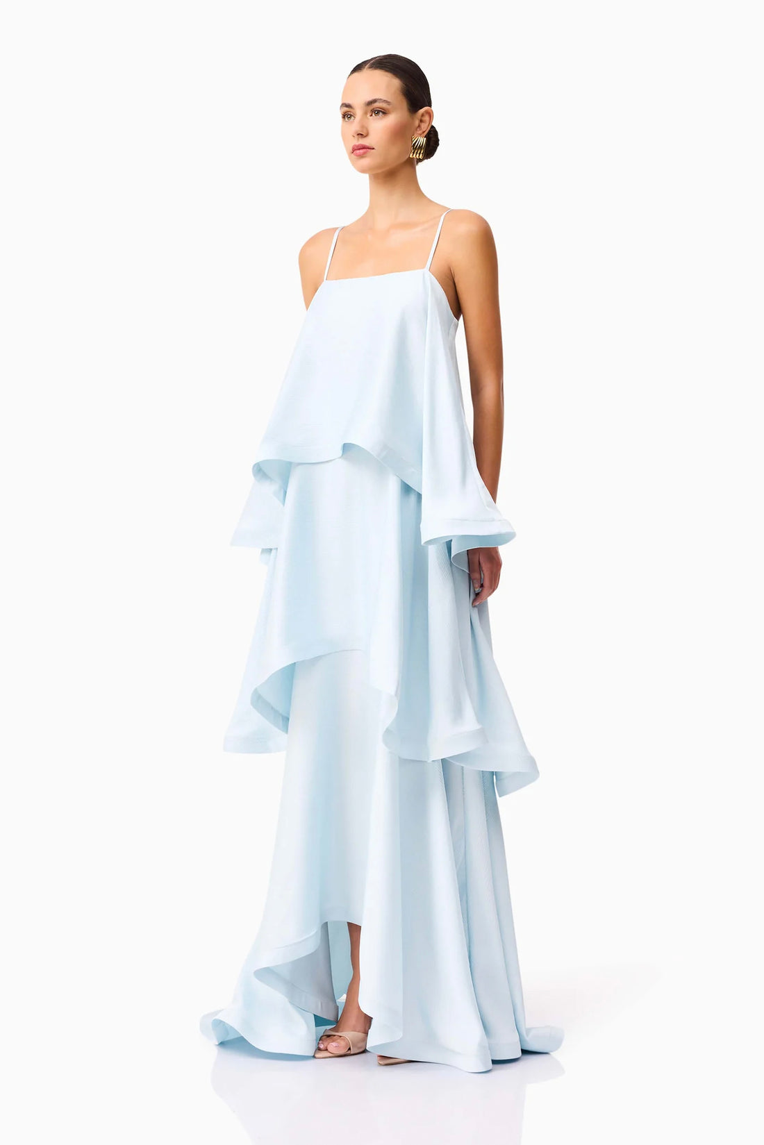 Full length sideview of woman wearing the ELLIATT Tilly Tiered Maxi Dress in pale blue