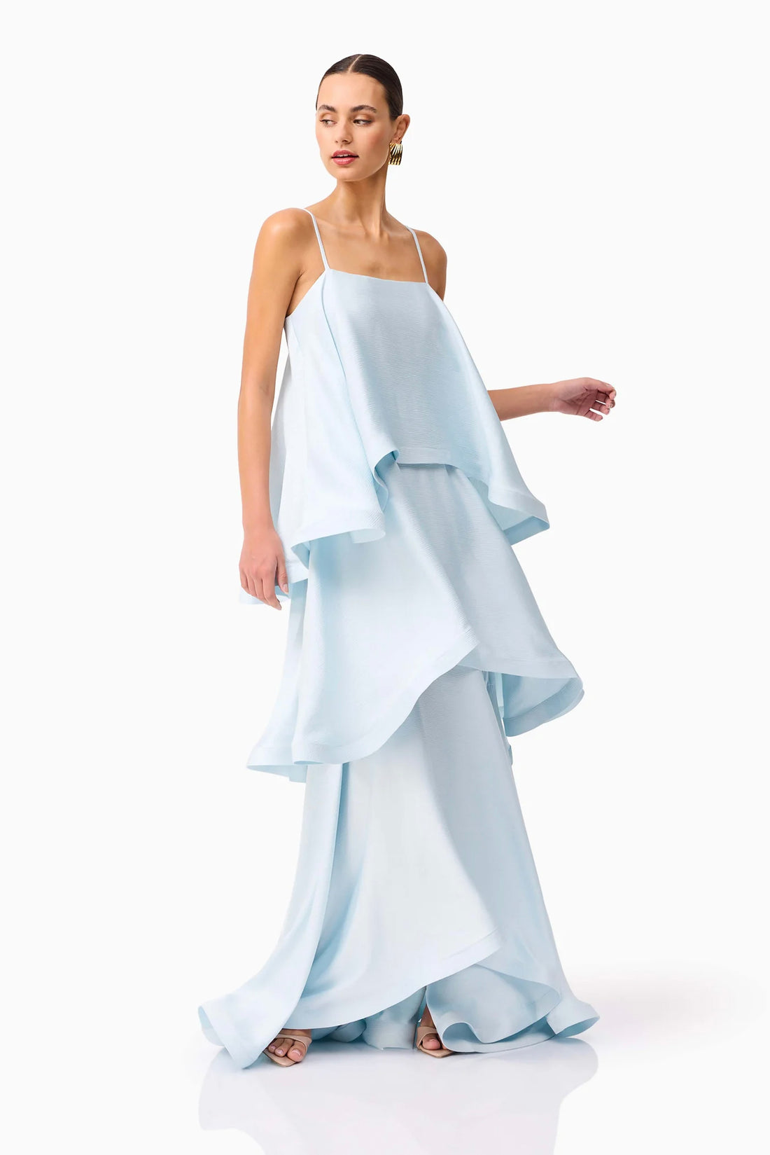 Woman wearing the ELLIATT Tilly Tiered Maxi Dress in pale blue