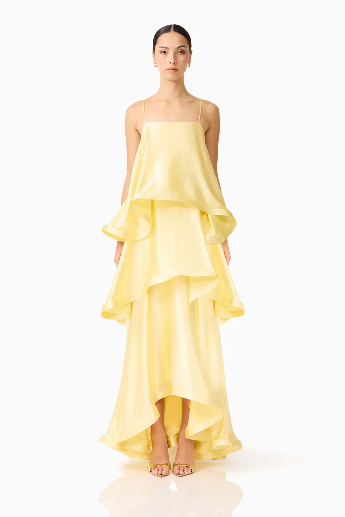 Woman wearing the ELLIATT Tilly Tiered Maxi Dress in butter yellow evening gown on a white background
