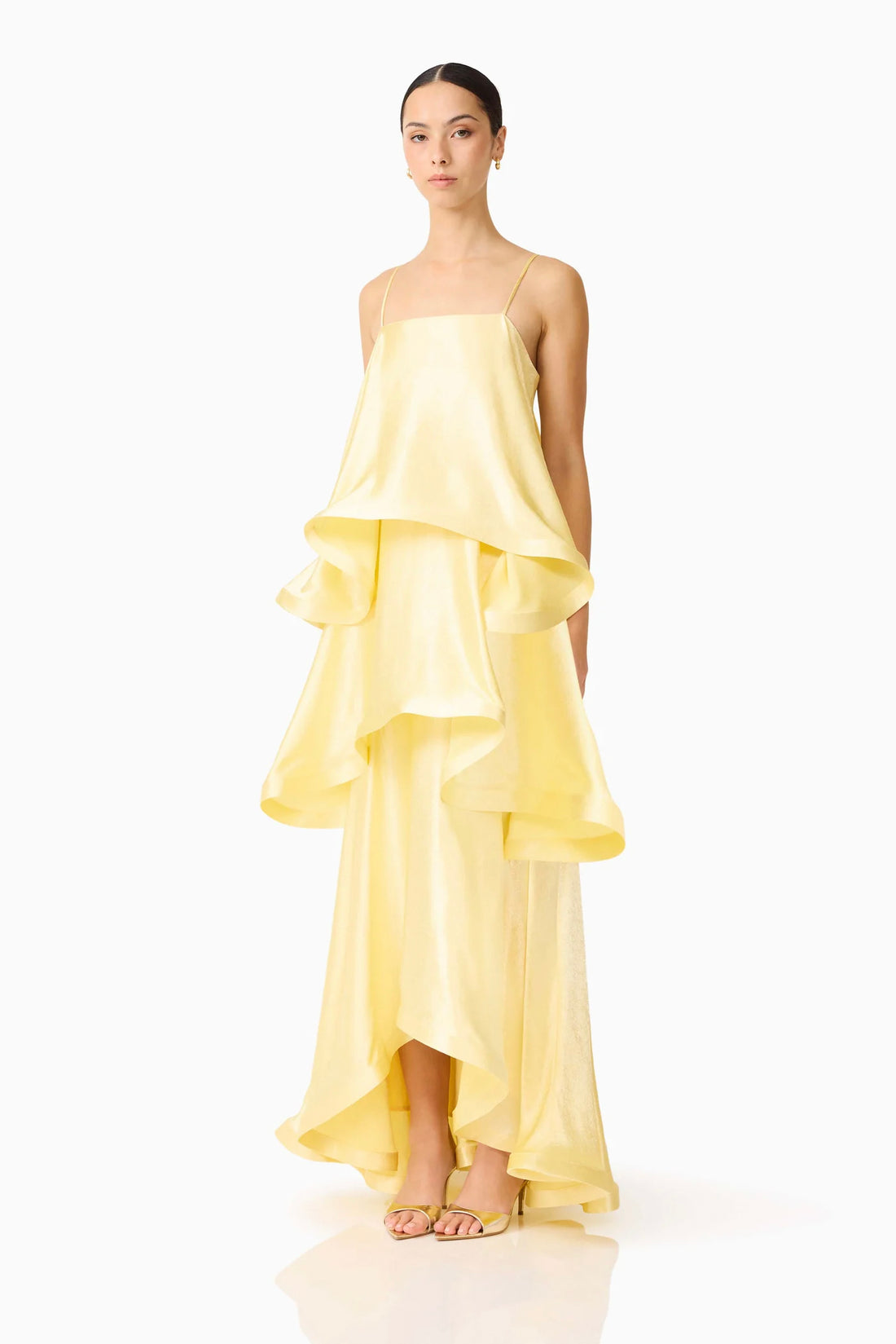 Woman wearing the ELLIATT Tilly Tiered Maxi Dress in butter yellow evening gown on a white background