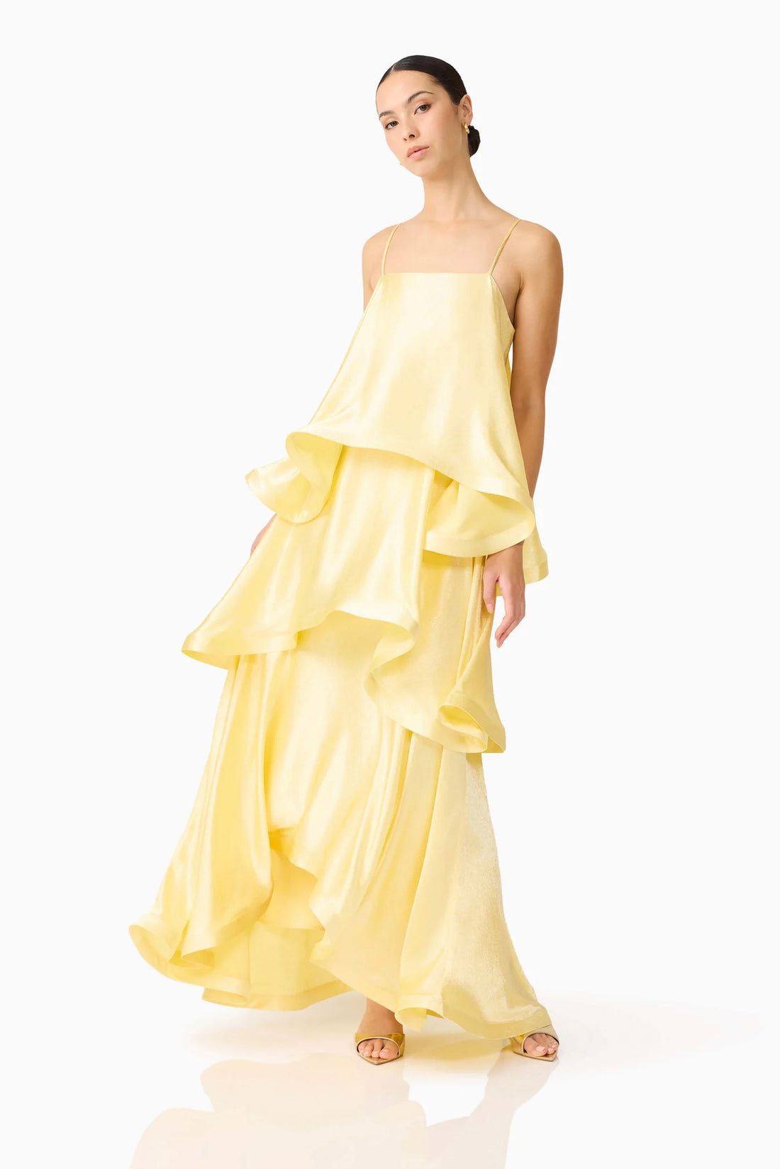 Woman wearing the ELLIATT Tilly Tiered Maxi Dress in butter yellow evening gown on a white background