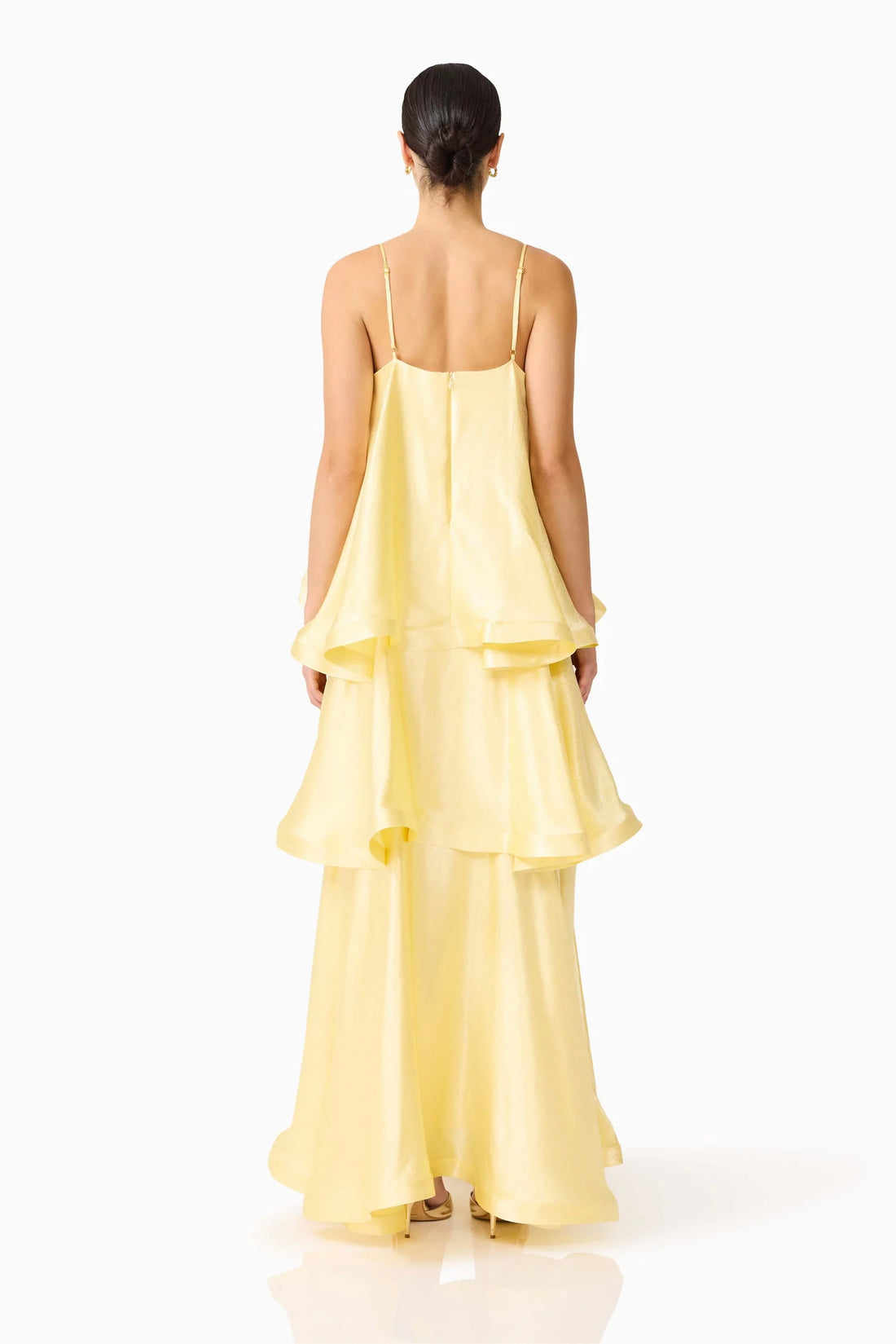 Back view of woman wearing the ELLIATT Tilly Tiered Maxi Dress in butter yellow evening gown on a white background