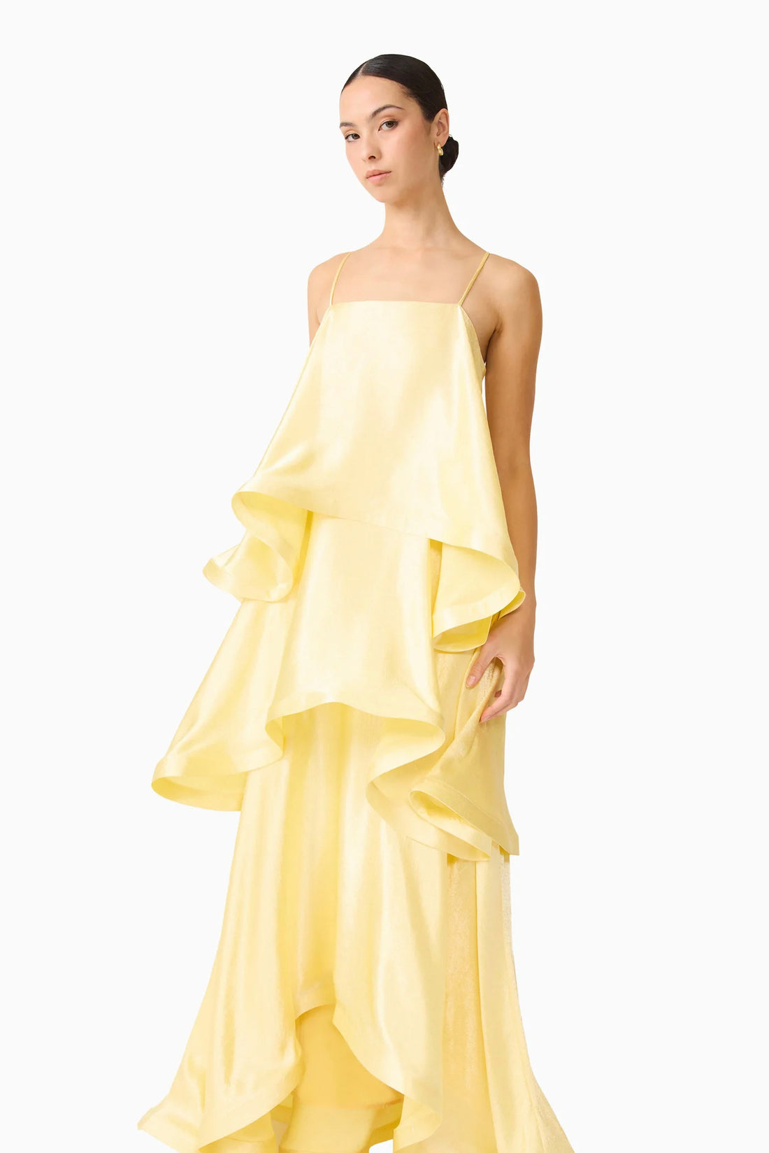 Close up of woman wearing the ELLIATT Tilly Tiered Maxi Dress in butter yellow evening gown on a white background