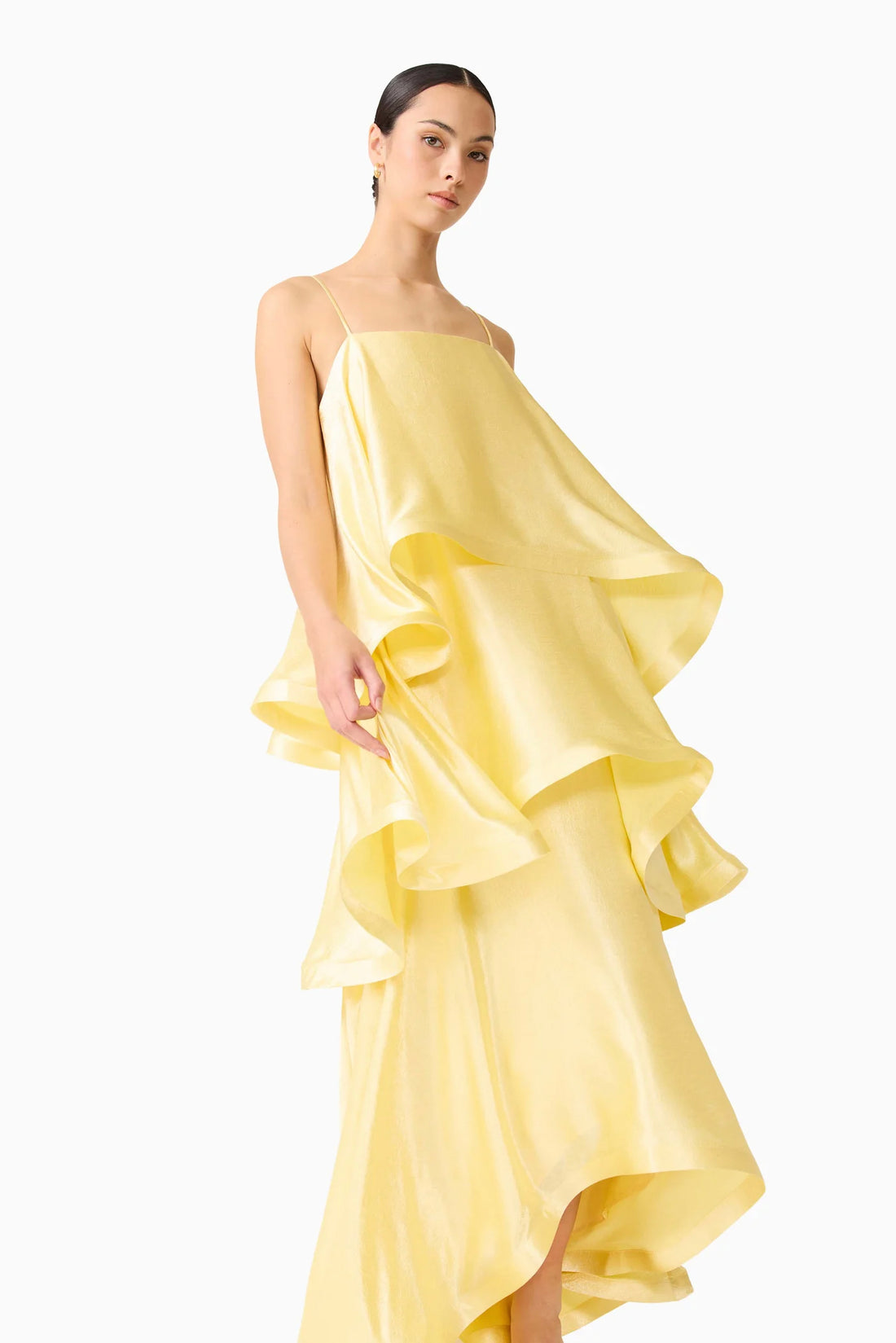 Woman wearing the ELLIATT Tilly Tiered Maxi Dress in butter yellow evening gown on a white background