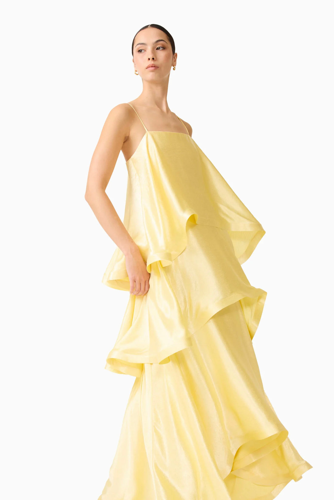 Woman wearing the ELLIATT Tilly Tiered Maxi Dress in butter yellow evening gown on a white background