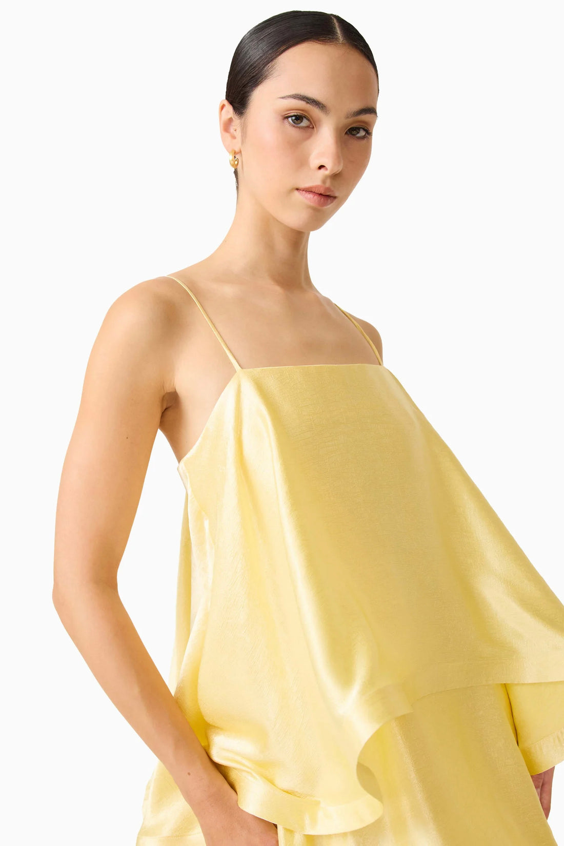 Close up detail of woman wearing the ELLIATT Tilly Tiered Maxi Dress in butter yellow evening gown on a white background