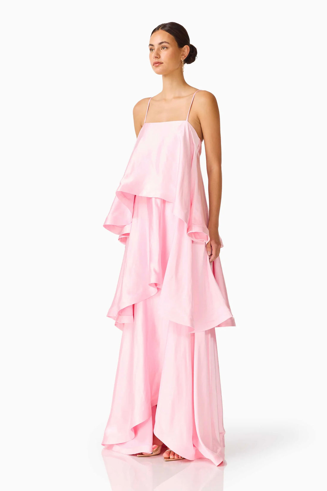 Woman wearing the ELLIATT Tilly Tiered   Maxi Dress in pale pink evening gown on a white background