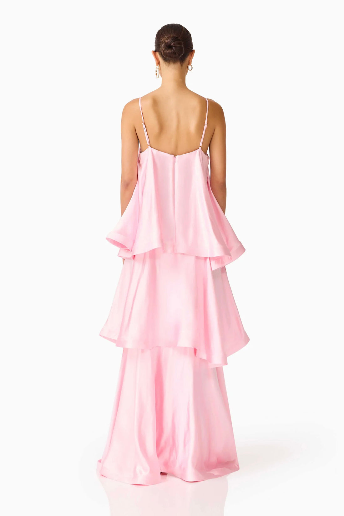 Back view of woman wearing the ELLIATT Tilly Tiered   Maxi Dress in pale pink evening gown on a white background