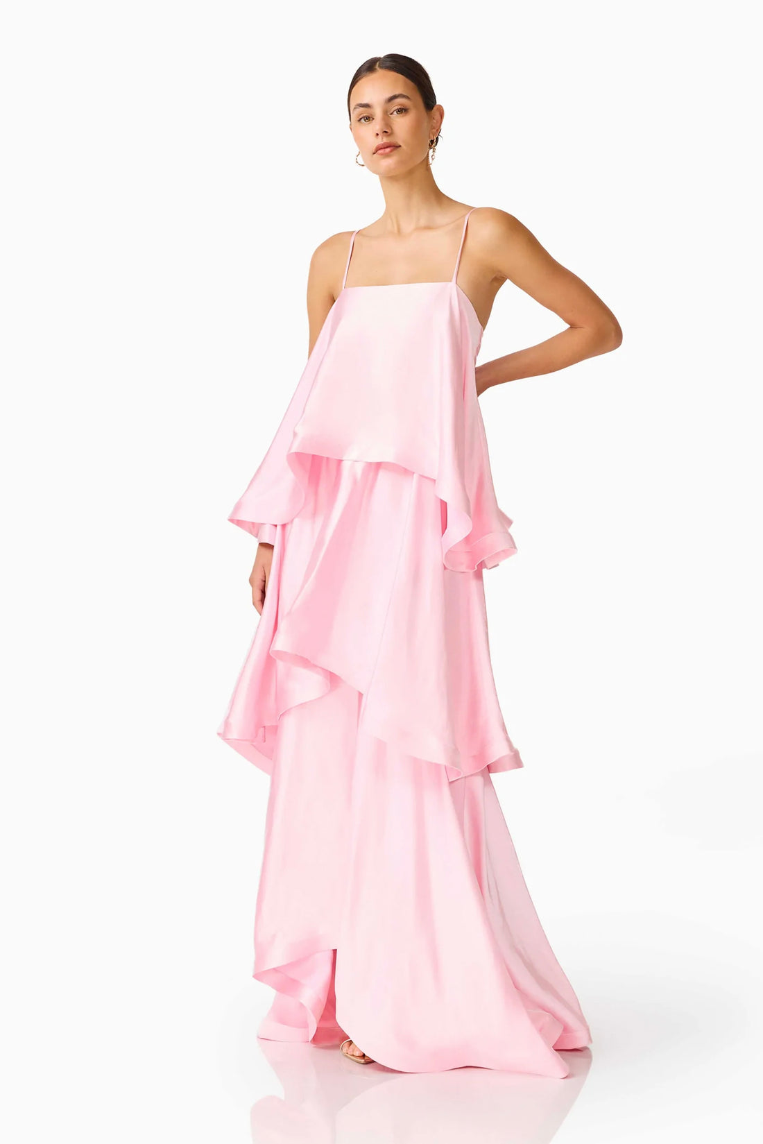 Woman wearing the ELLIATT Tilly Tiered Maxi Dress in pale pink evening gown on a white background