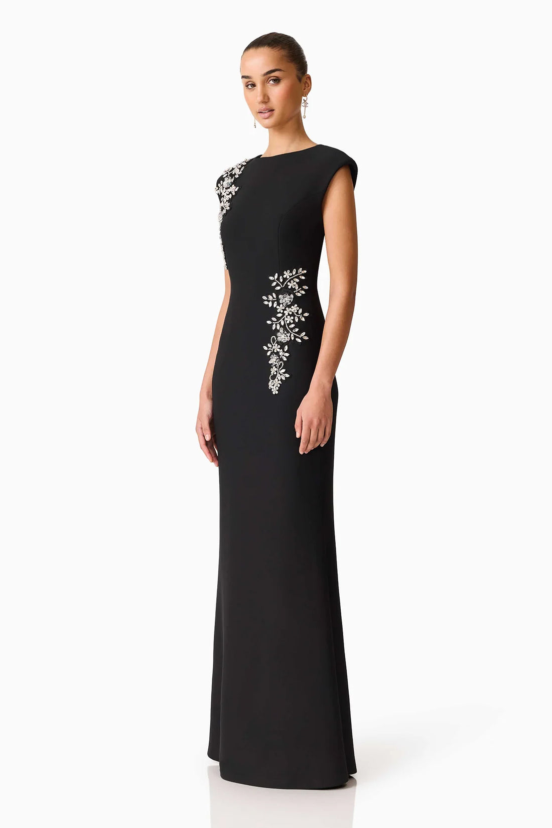 Side full length view of woman wearing the ELLIATT Veda Gown in black with diamante embellishments