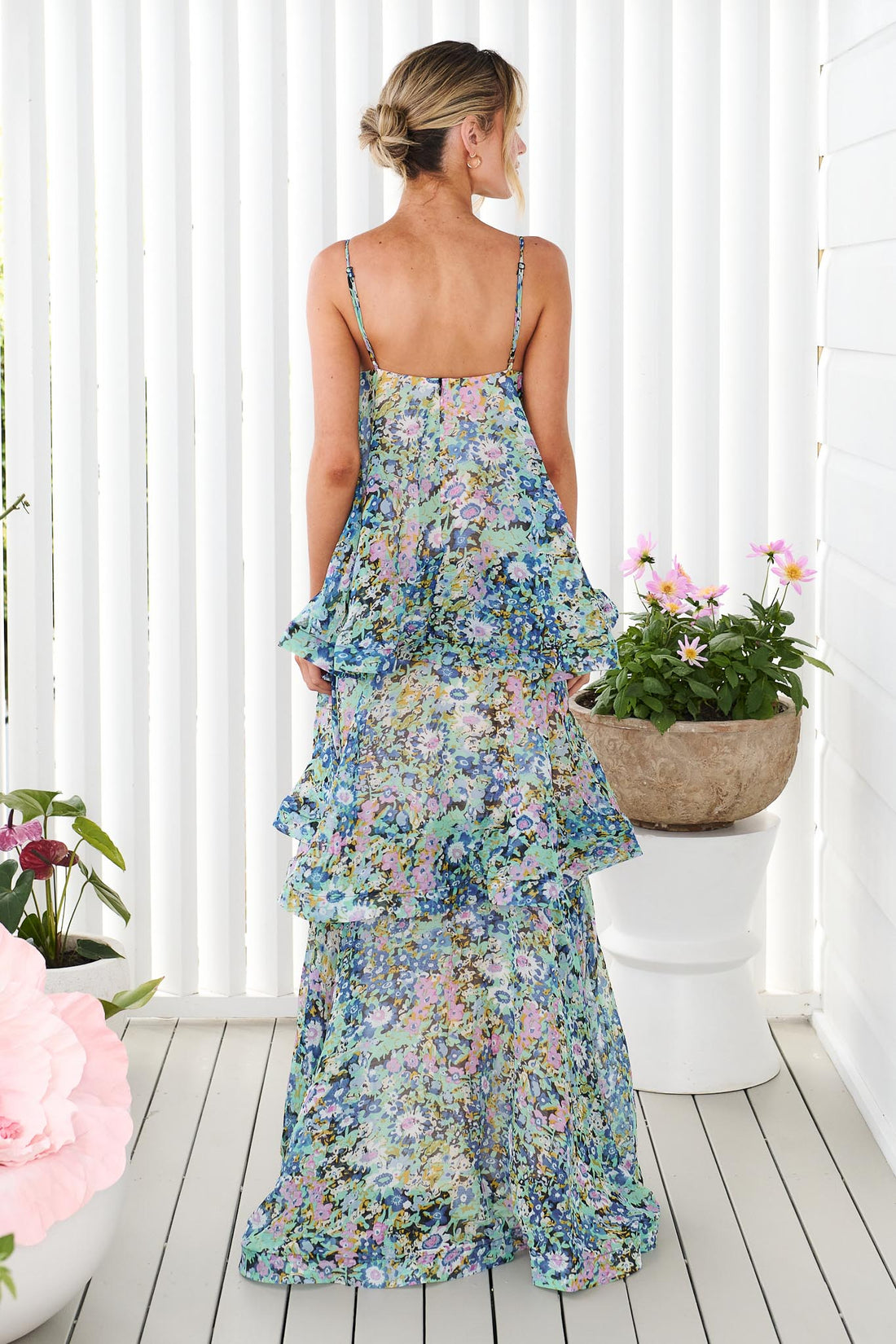 Back view of woman wearing the Armani Tiered Maxi Dress in Blue Floral by ELLIATT