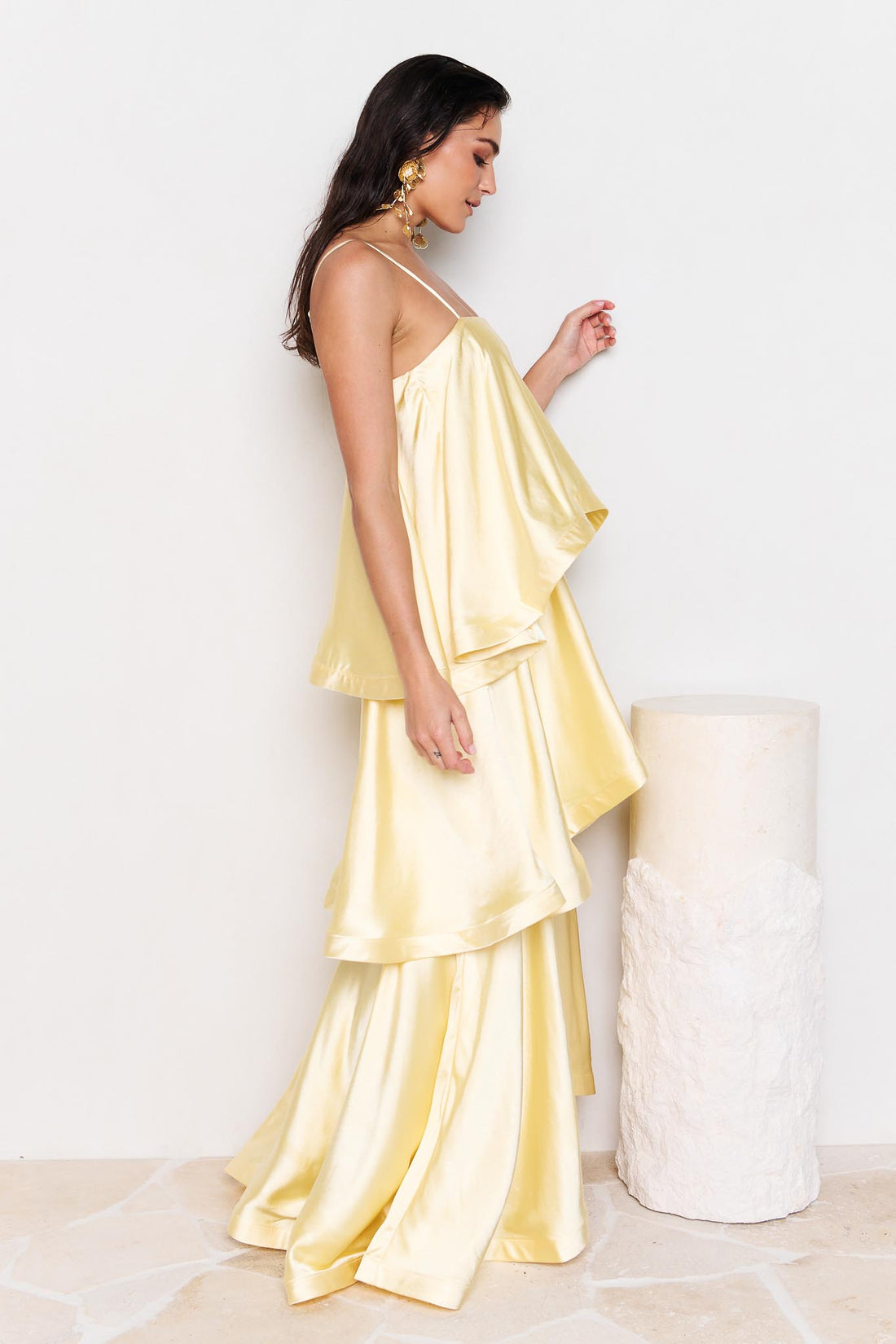 Woman wearing the ELLIATT Tilly Tiered Maxi Dress in butter yellow evening gown on a white background