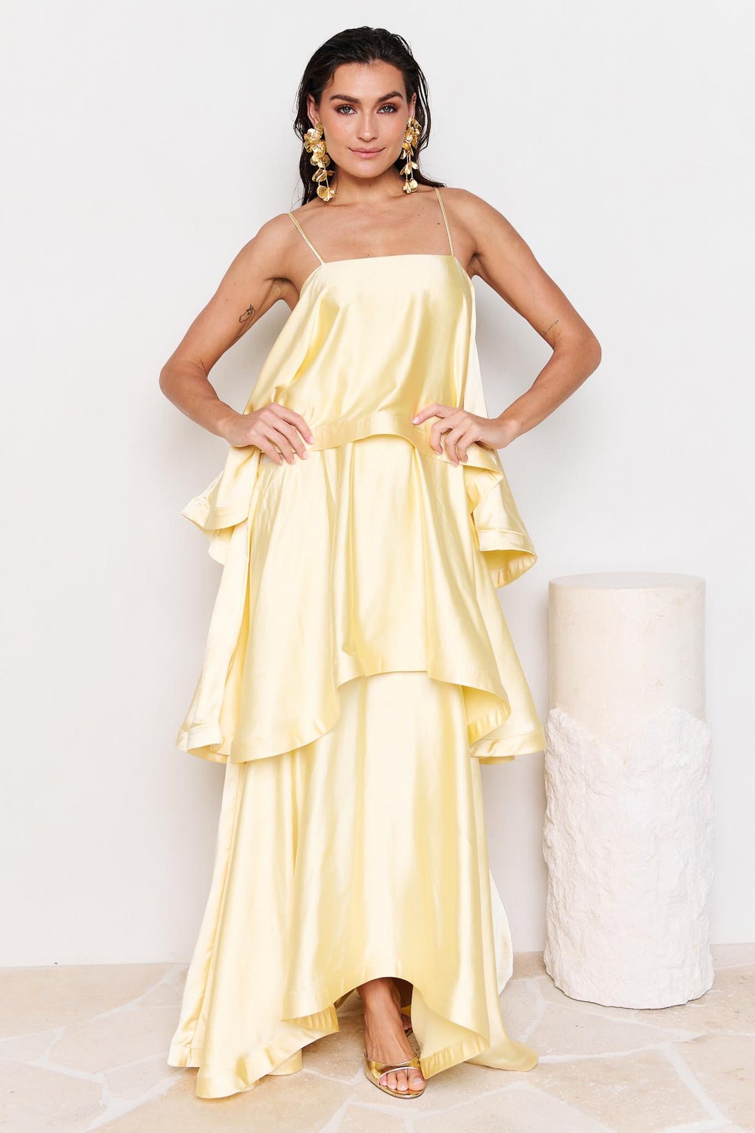 Woman wearing the ELLIATT Tilly Tiered Maxi Dress in butter yellow evening gown on a white background