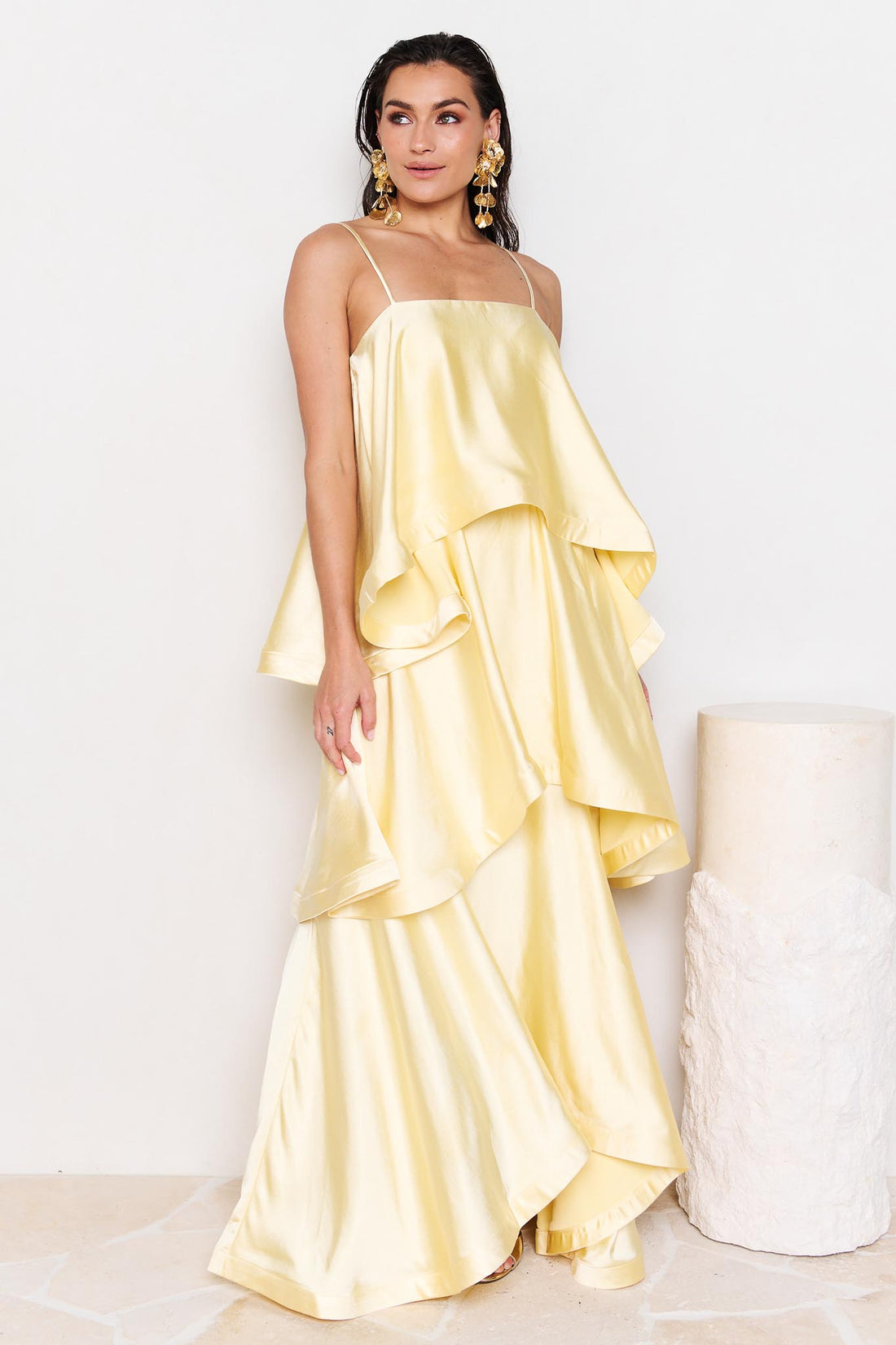 Woman wearing the ELLIATT Tilly Tiered Maxi Dress in butter yellow evening gown on a white background