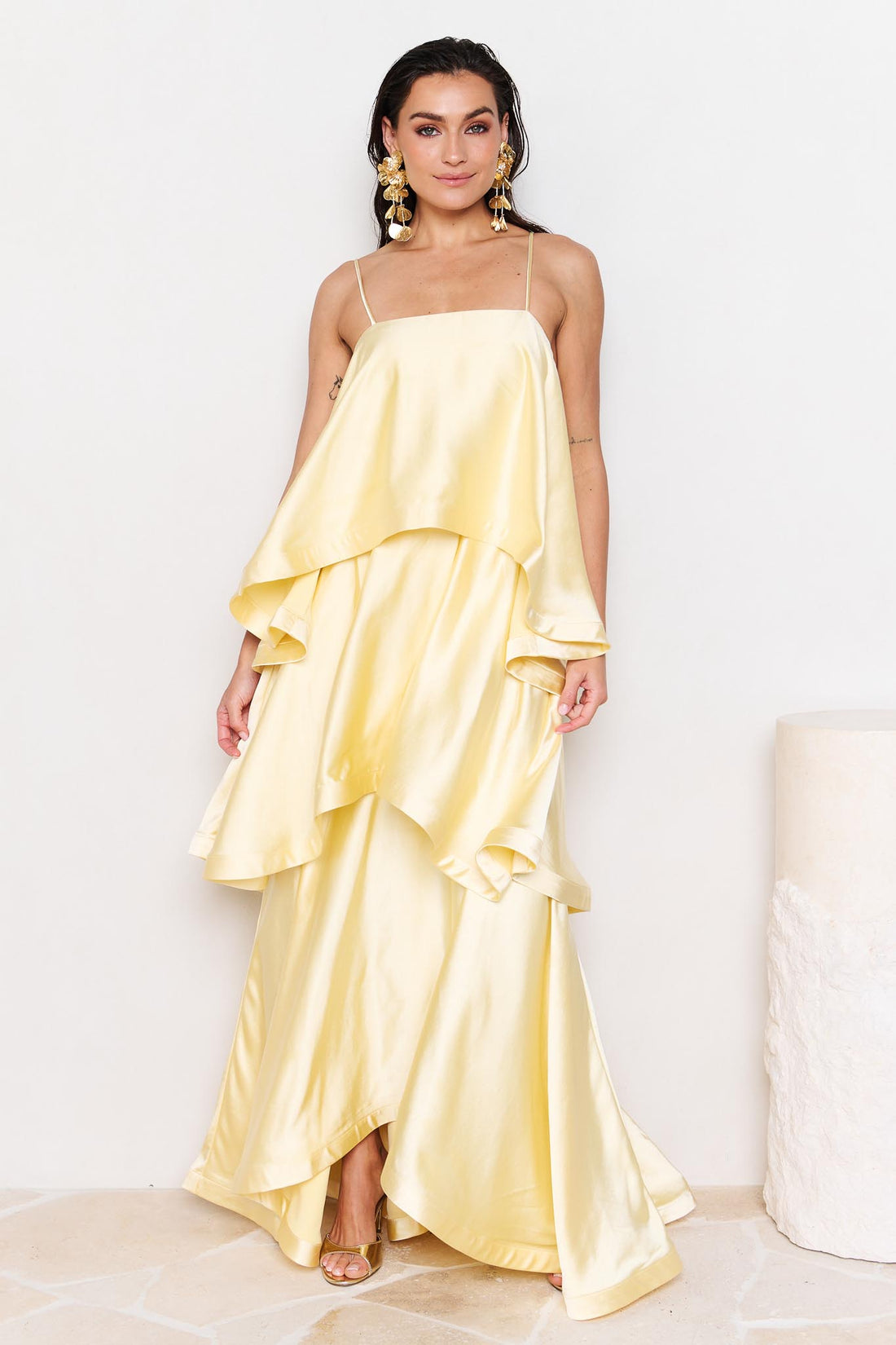 Woman wearing the ELLIATT Tilly Tiered Maxi Dress in butter yellow evening gown on a white background