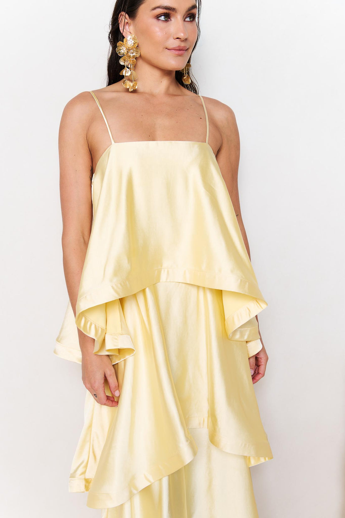 Detail of the ELLIATT Tilly Tiered Maxi Dress in butter yellow evening gown on a white background