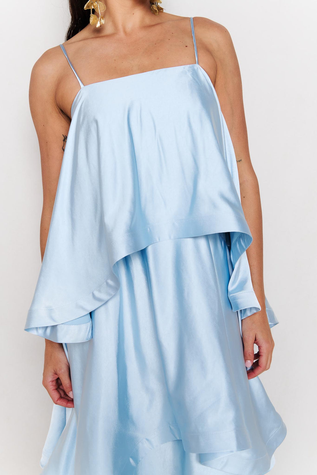 Close up of woman wearing the ELLIATT Tilly Tiered Maxi Dress in pale blue evening gown on a white background