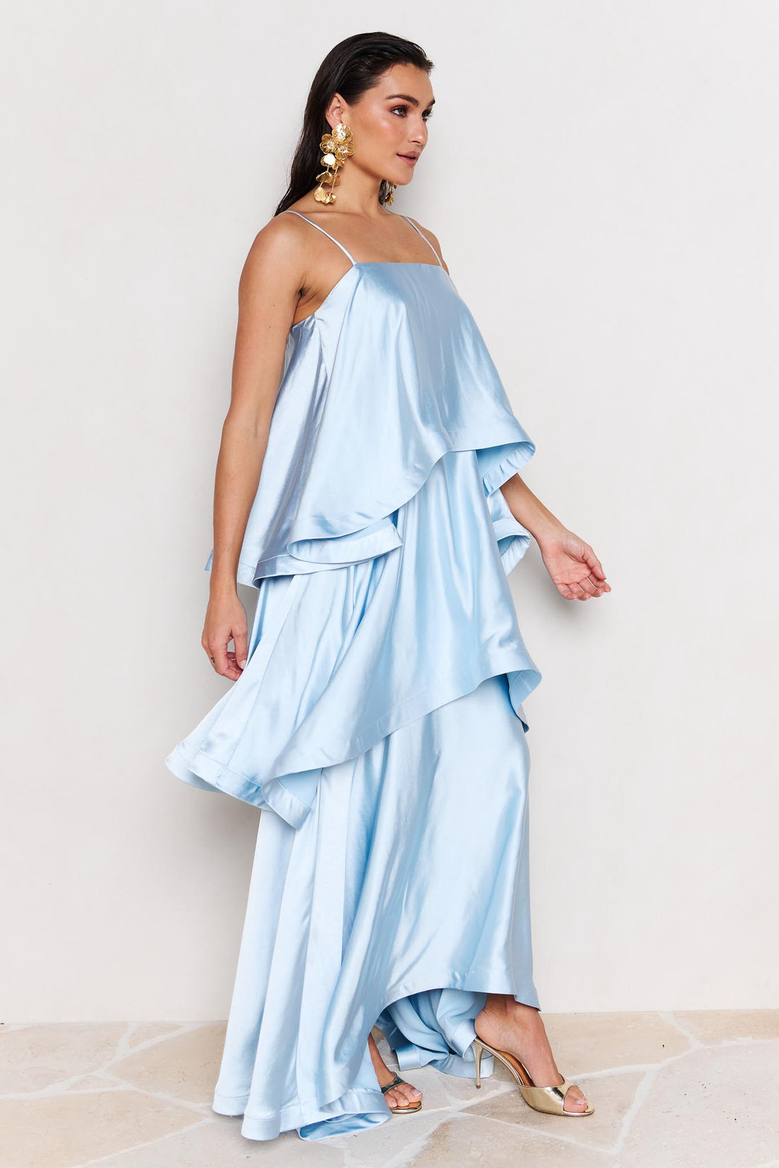Side view of woman wearing the ELLIATT Tilly Tiered Maxi Dress in pale blue evening gown on a white background