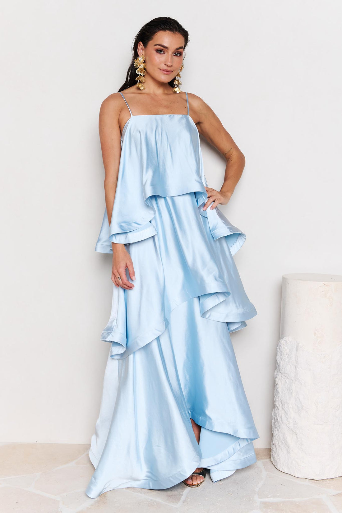 Woman wearing the ELLIATT Tilly Tiered Maxi Dress in pale blue evening gown on a white background