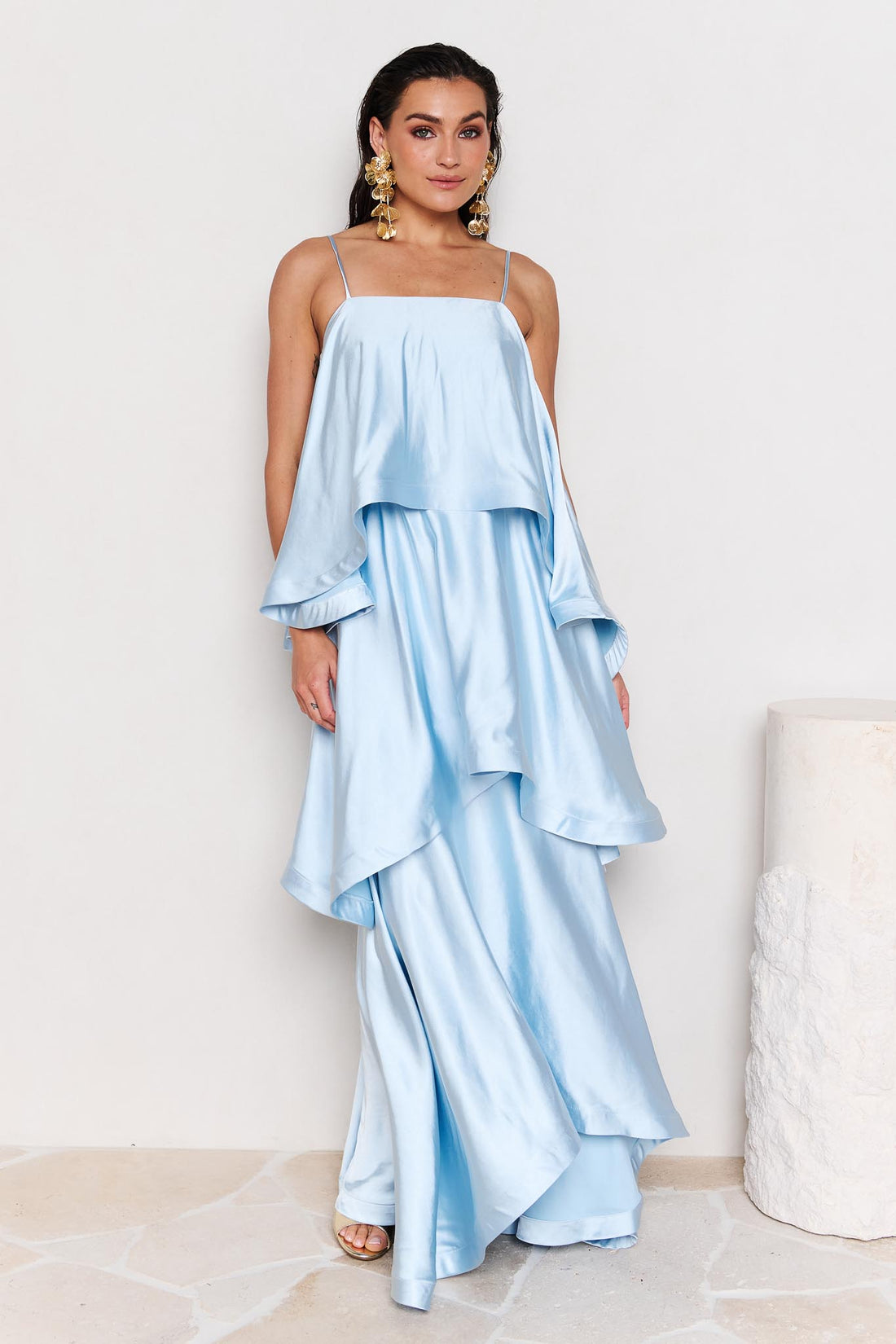 Woman wearing the ELLIATT Tilly Tiered Maxi Dress in pale blue evening gown on a white background