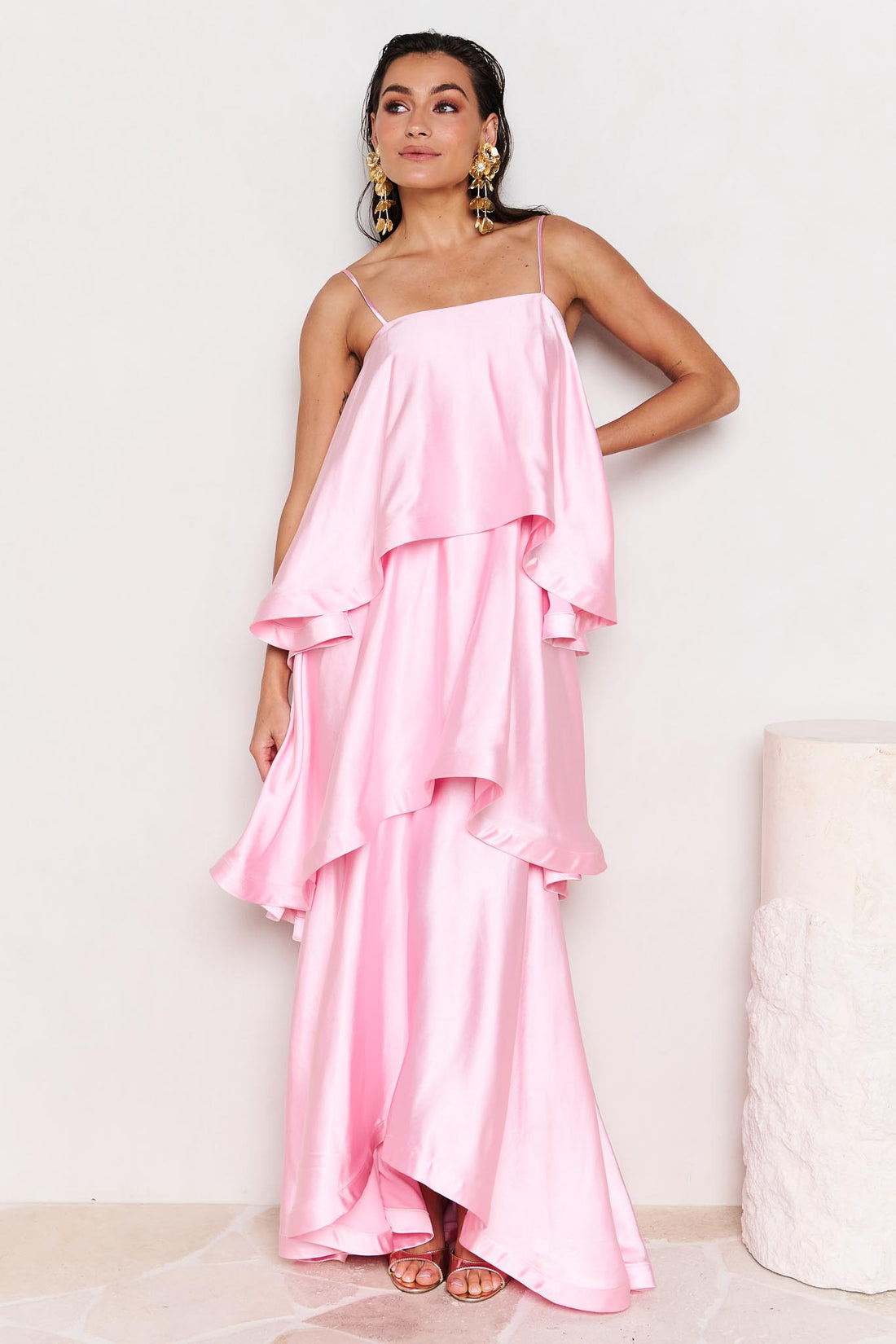 Woman wearing the ELLIATT Tilly Tiered Maxi Dress in pale pink evening gown on a white background