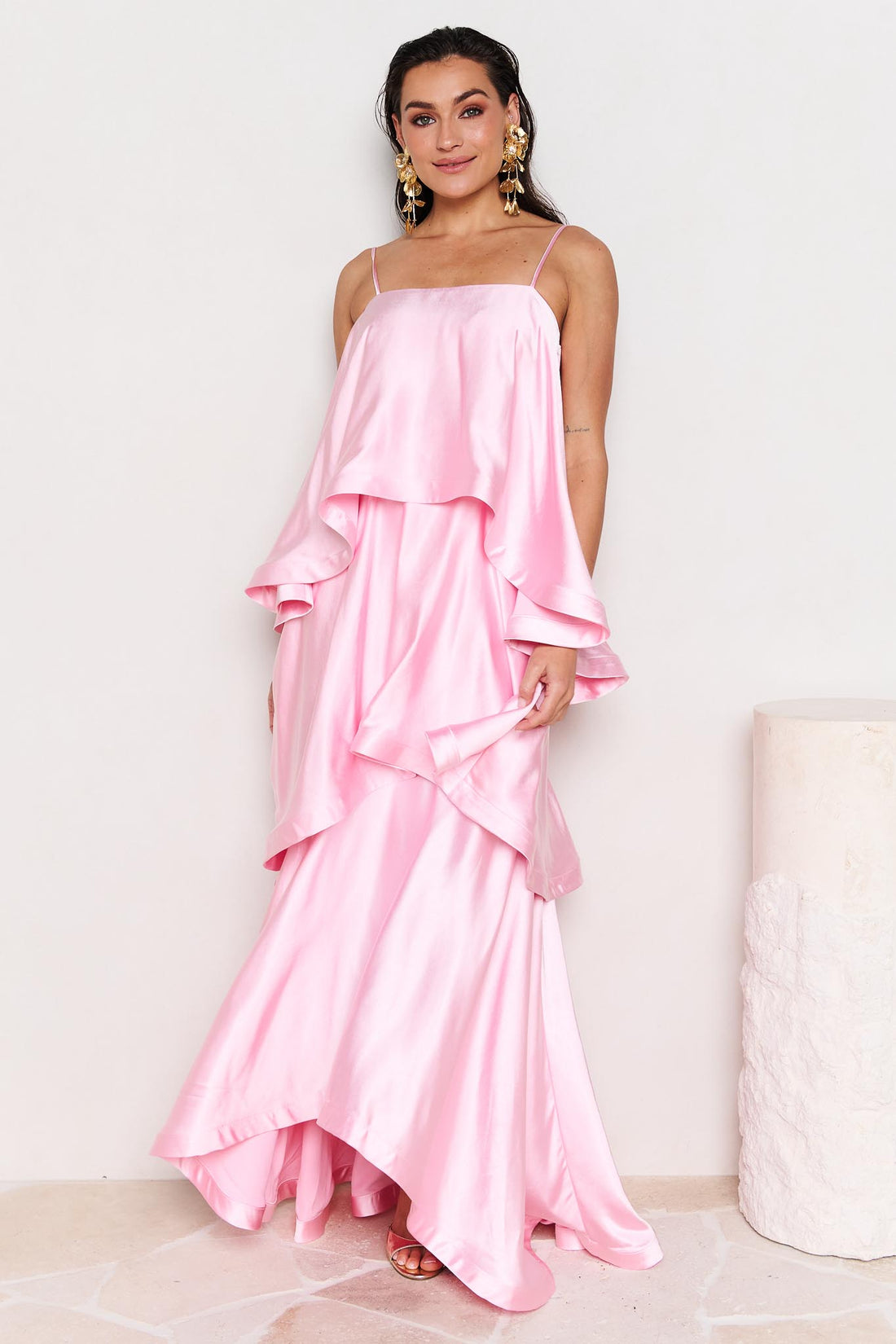 Woman wearing the ELLIATT Tilly Tiered Maxi Dress in pale pink evening gown on a white background