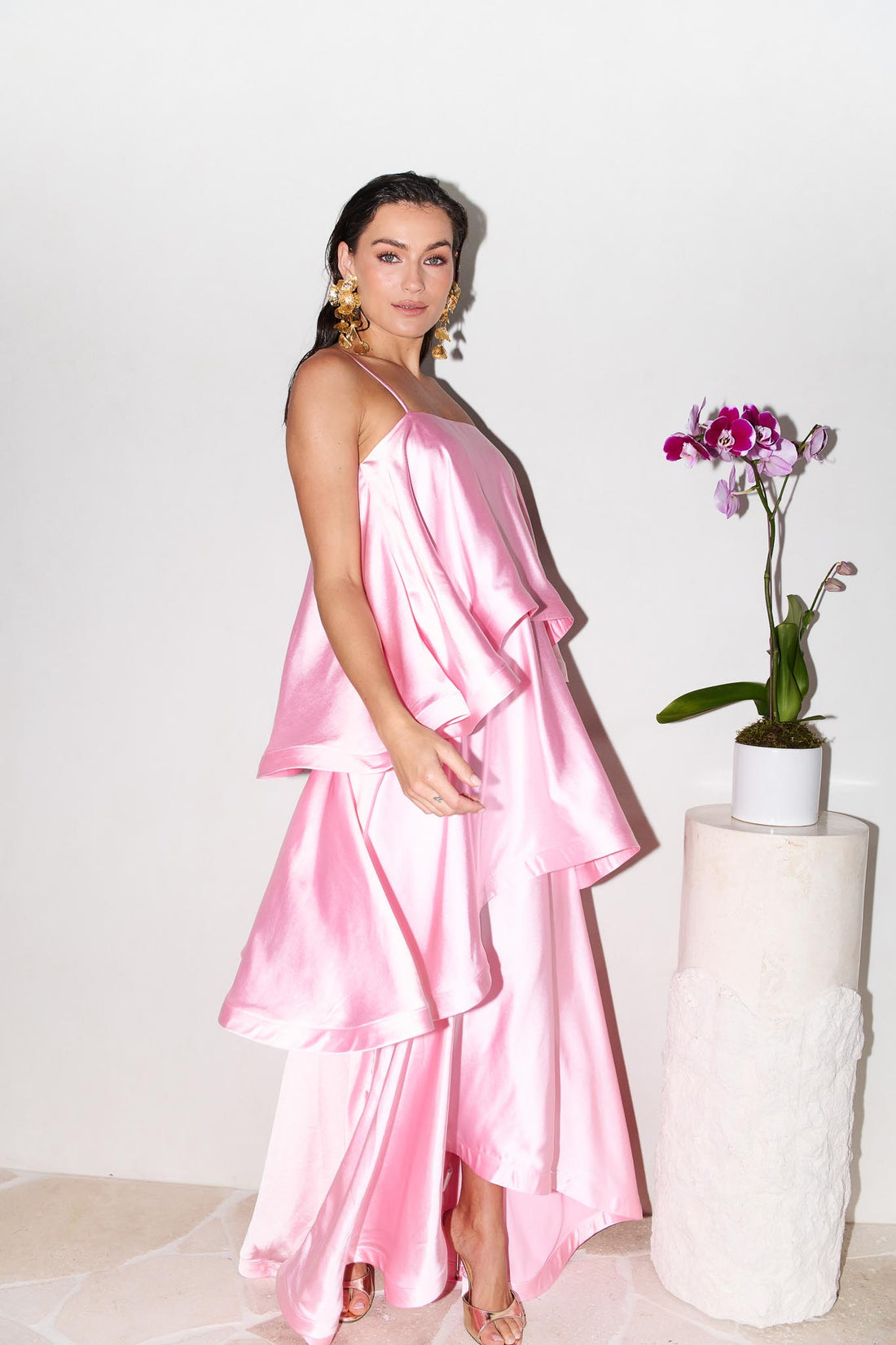 Woman wearing the ELLIATT Tilly Tiered Maxi Dress in pale pink evening gown on a white background