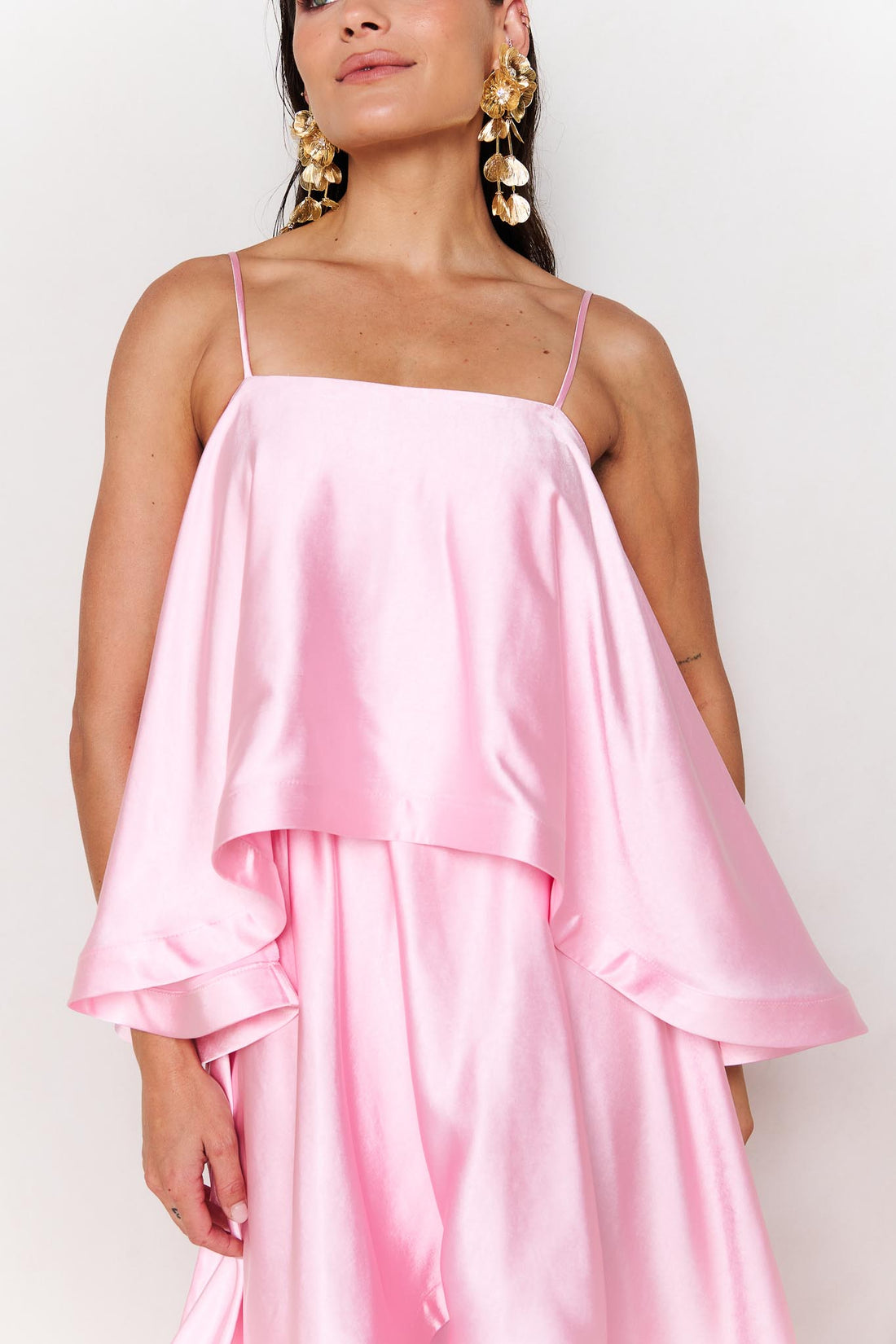 Close up of woman wearing the ELLIATT Tilly Tiered Maxi Dress in pale pink evening gown on a white background