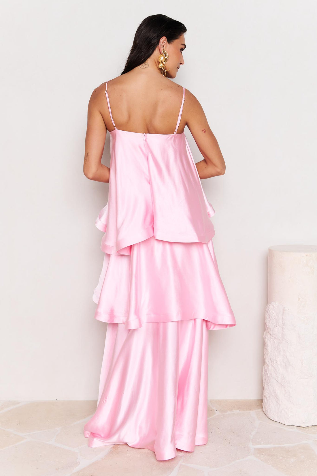 Back view of woman wearing the ELLIATT Tilly Tiered Maxi Dress in pale pink evening gown on a white background