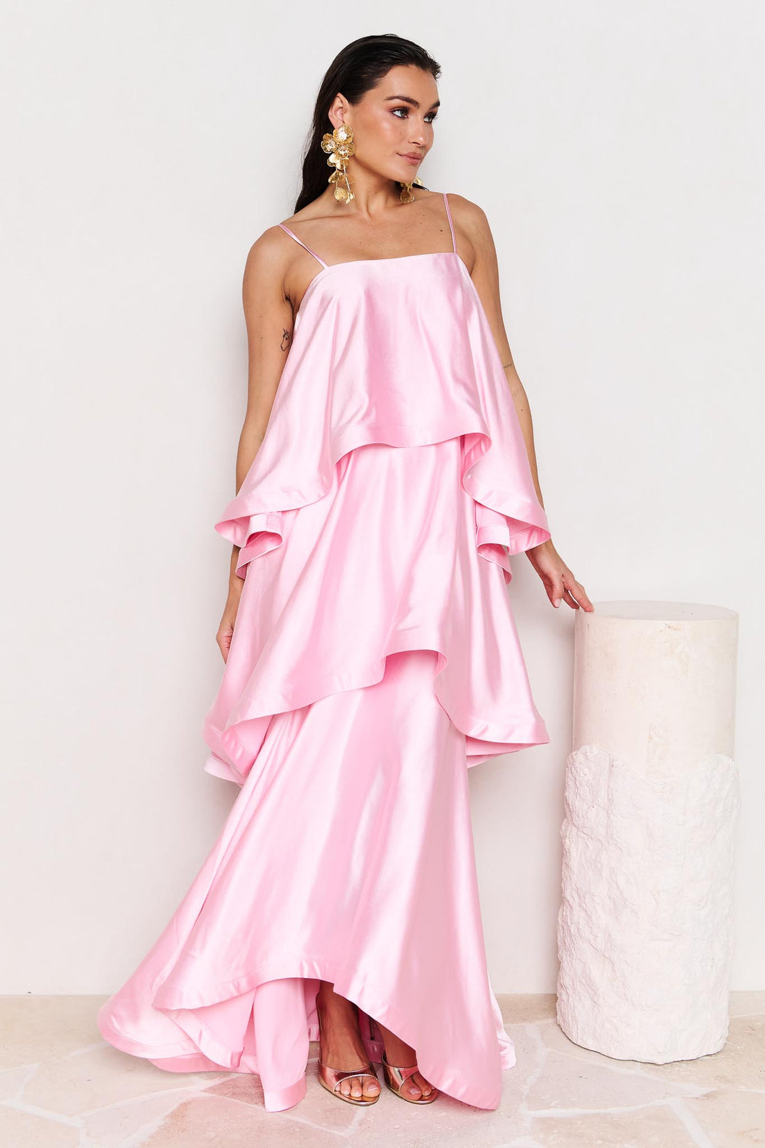 Woman wearing the ELLIATT Tilly Tiered Maxi Dress in pale pink evening gown on a white background