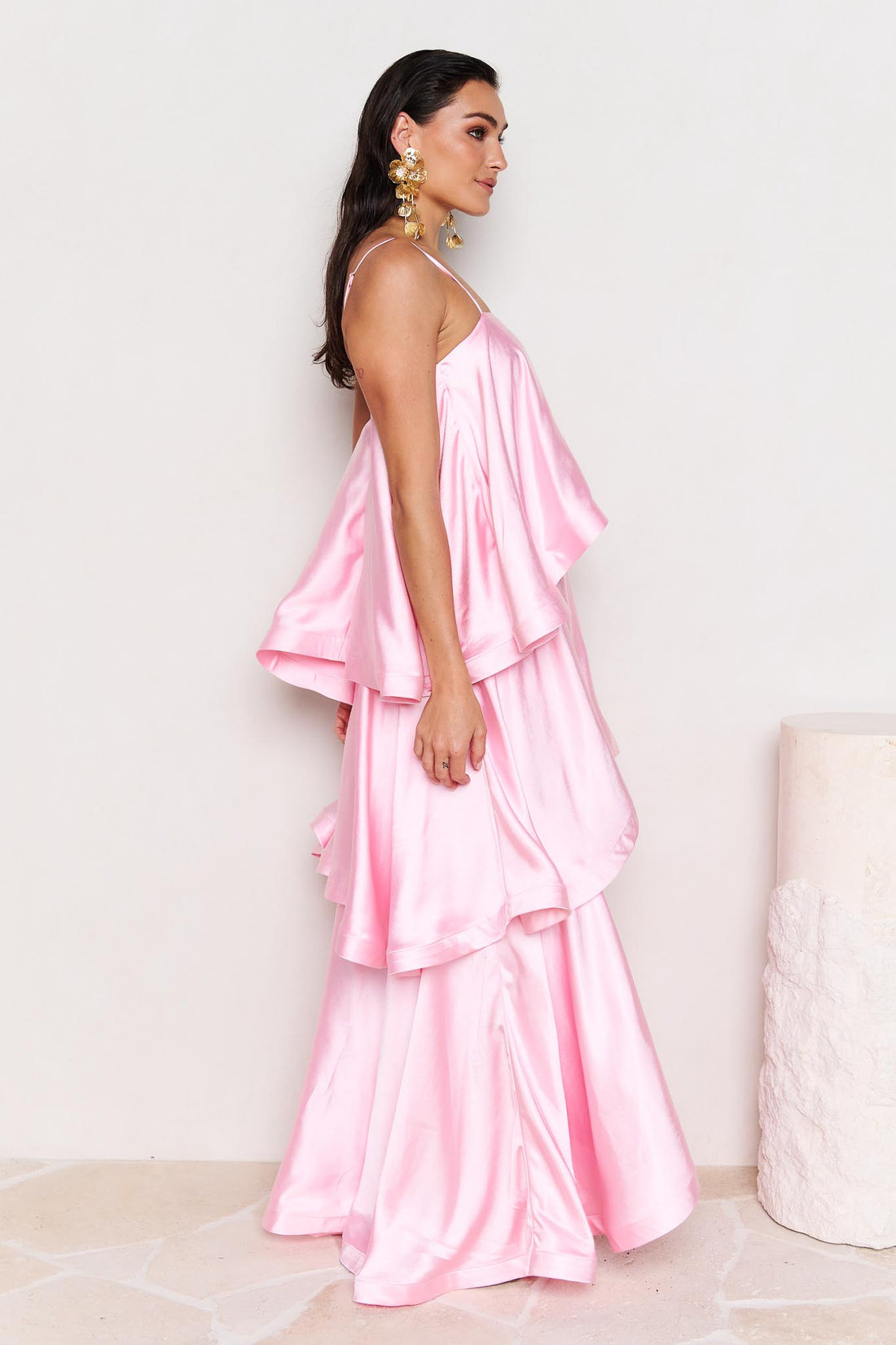 Woman wearing the ELLIATT Tilly Tiered Maxi Dress in pale pink evening gown on a white background