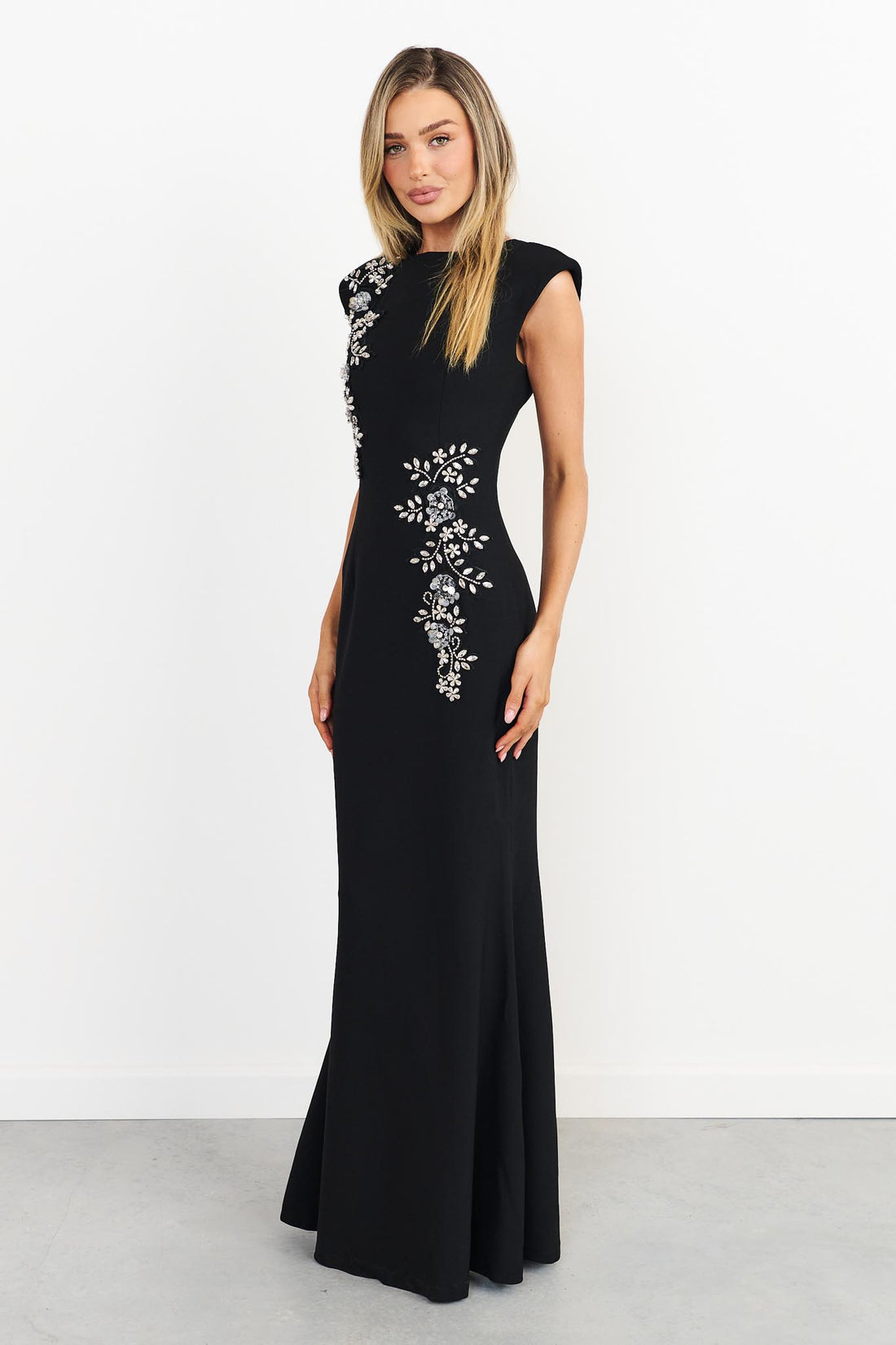Side view of woman wearing the ELLIATT Veda Gown in black with diamante embellishments