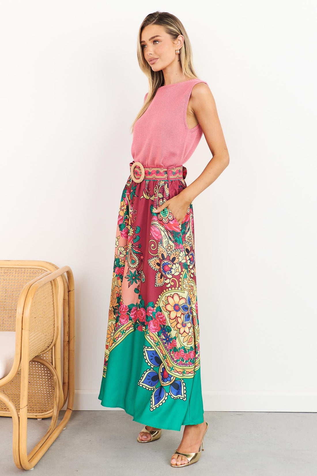 Franca paisley print maxi skirt with woven buckle belt and pink Villa knit tank, side view