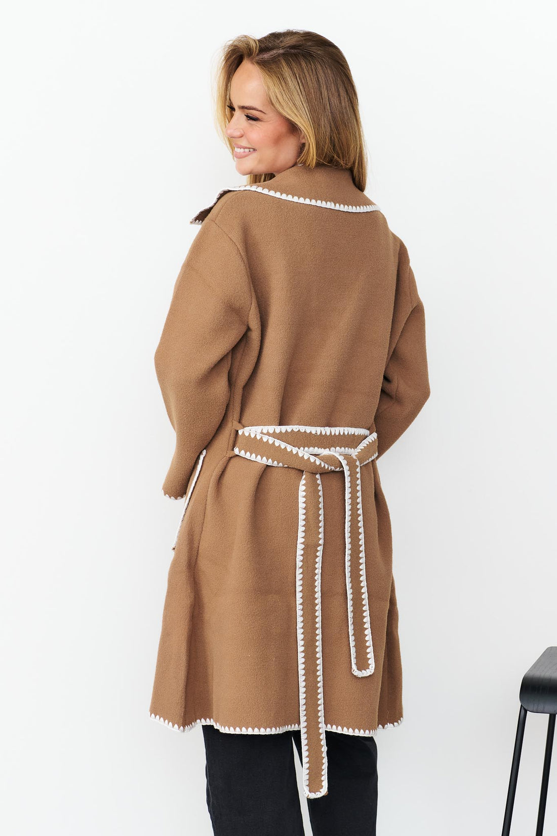 Back view of woman wearing minnie + MAXXIE wool blend Kinsey jacket in pecan with white blanket stitch trims.
