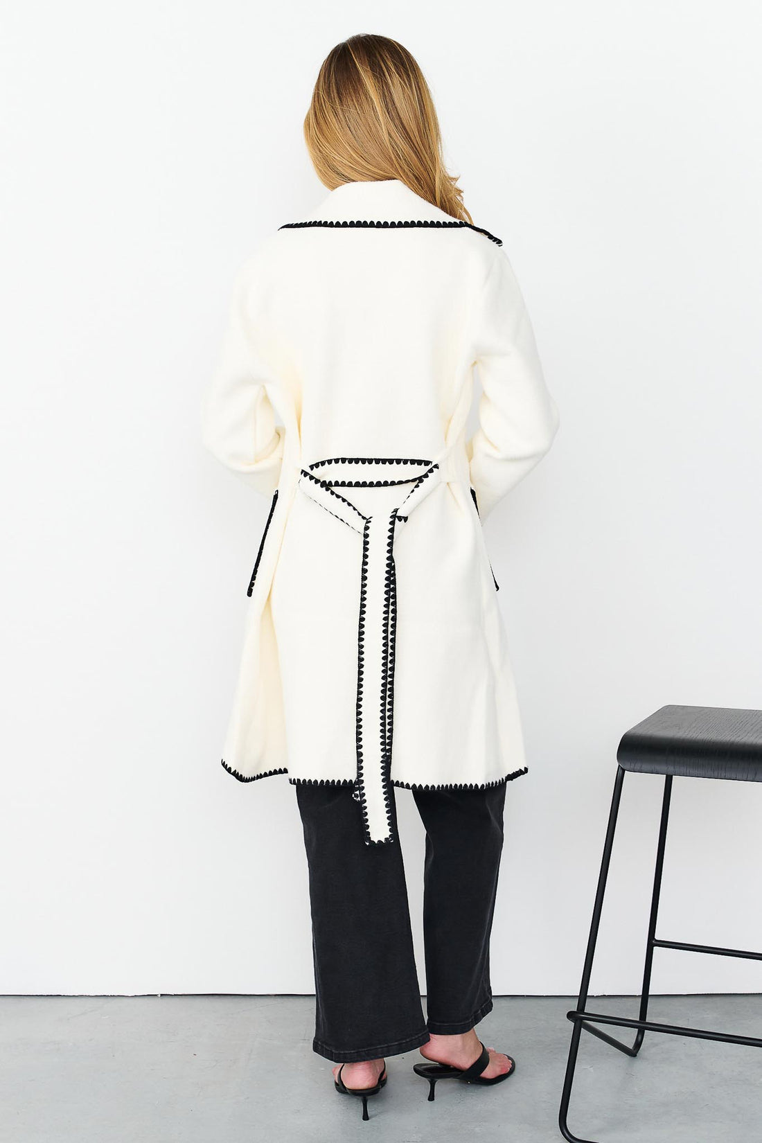 Back view of minnie + MAXXIE wool blend ivory Kinsey jacket with black blanket stitch trim.