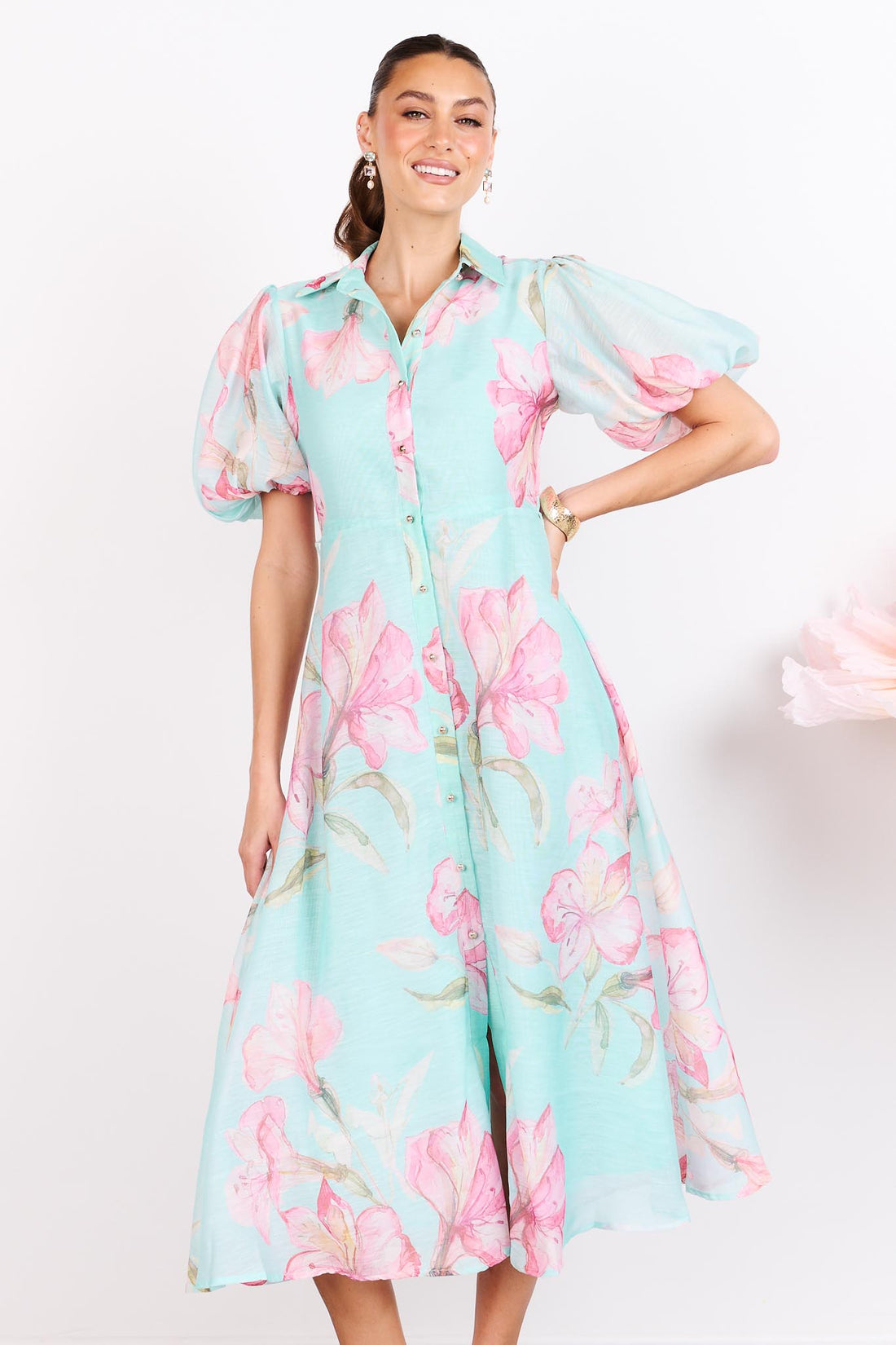 Woman wearing the minnie + MAXXIE La Belle aqua midi event dress with short puff sleeves.