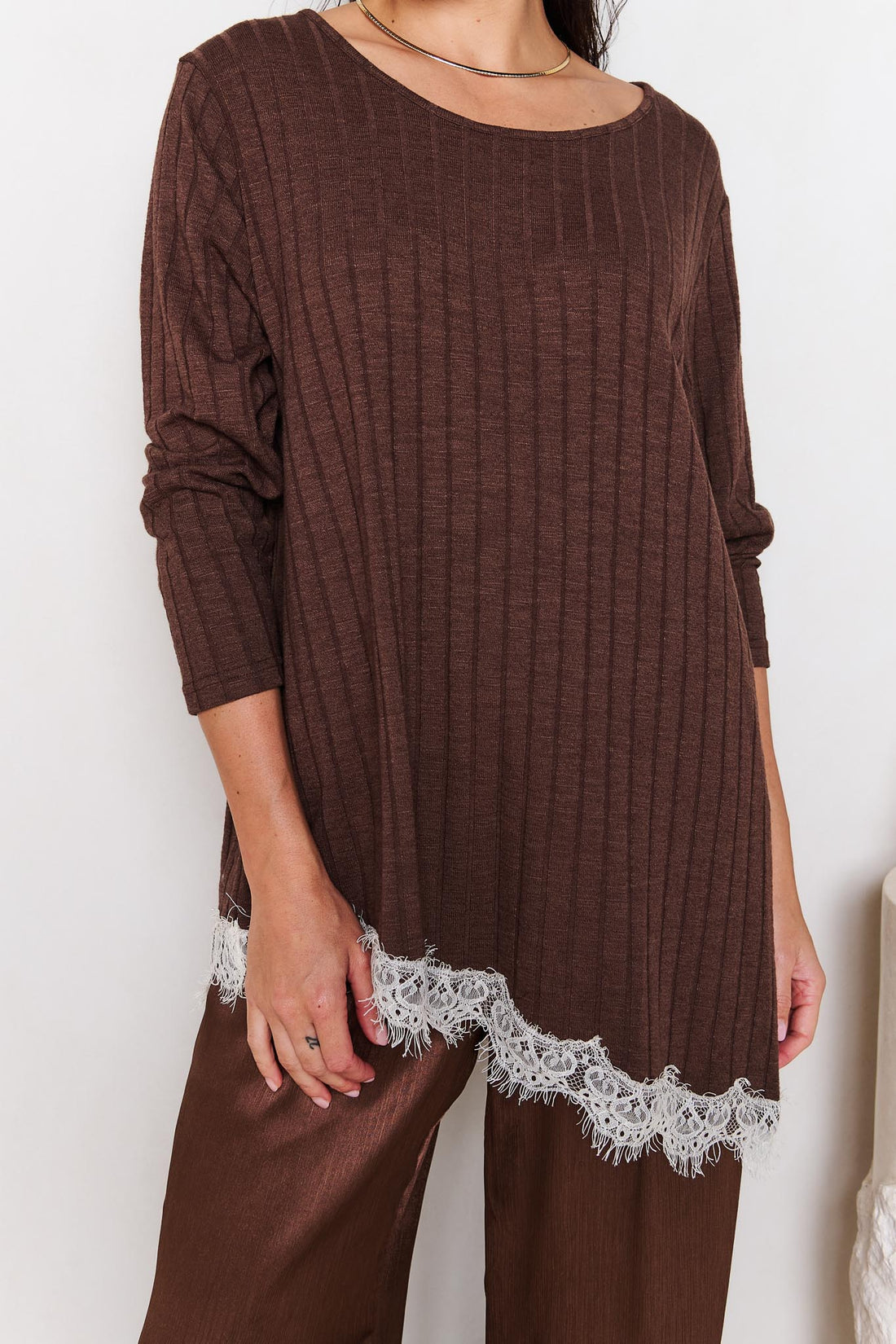 Brown ribbed knit top with lace trim with matching satin pants on a white background