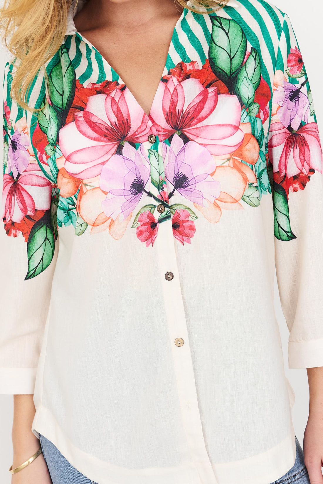 Detail of Mia Shirt in green with colourful floral patterns and stripes.