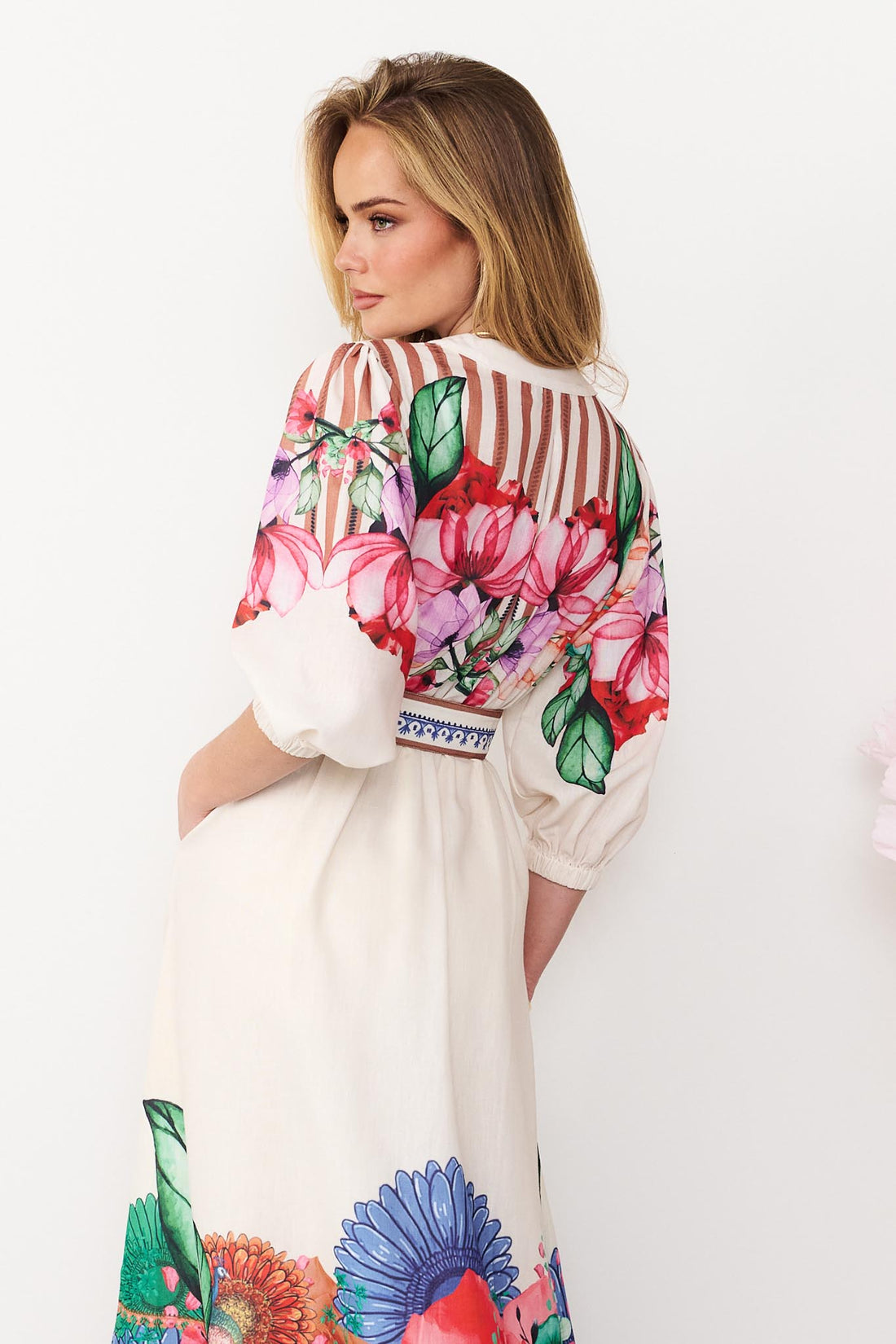 Back view of Rosabella dress with a bright floral and stripe print