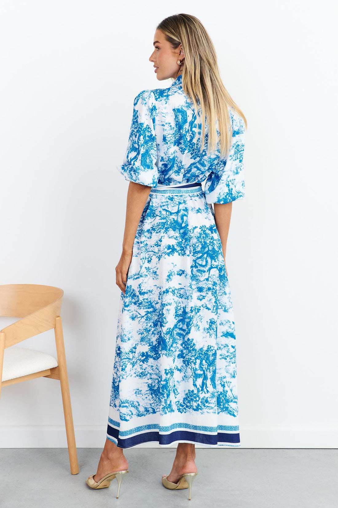 Back view of blue toile print shirt dress with stripe waist tie
