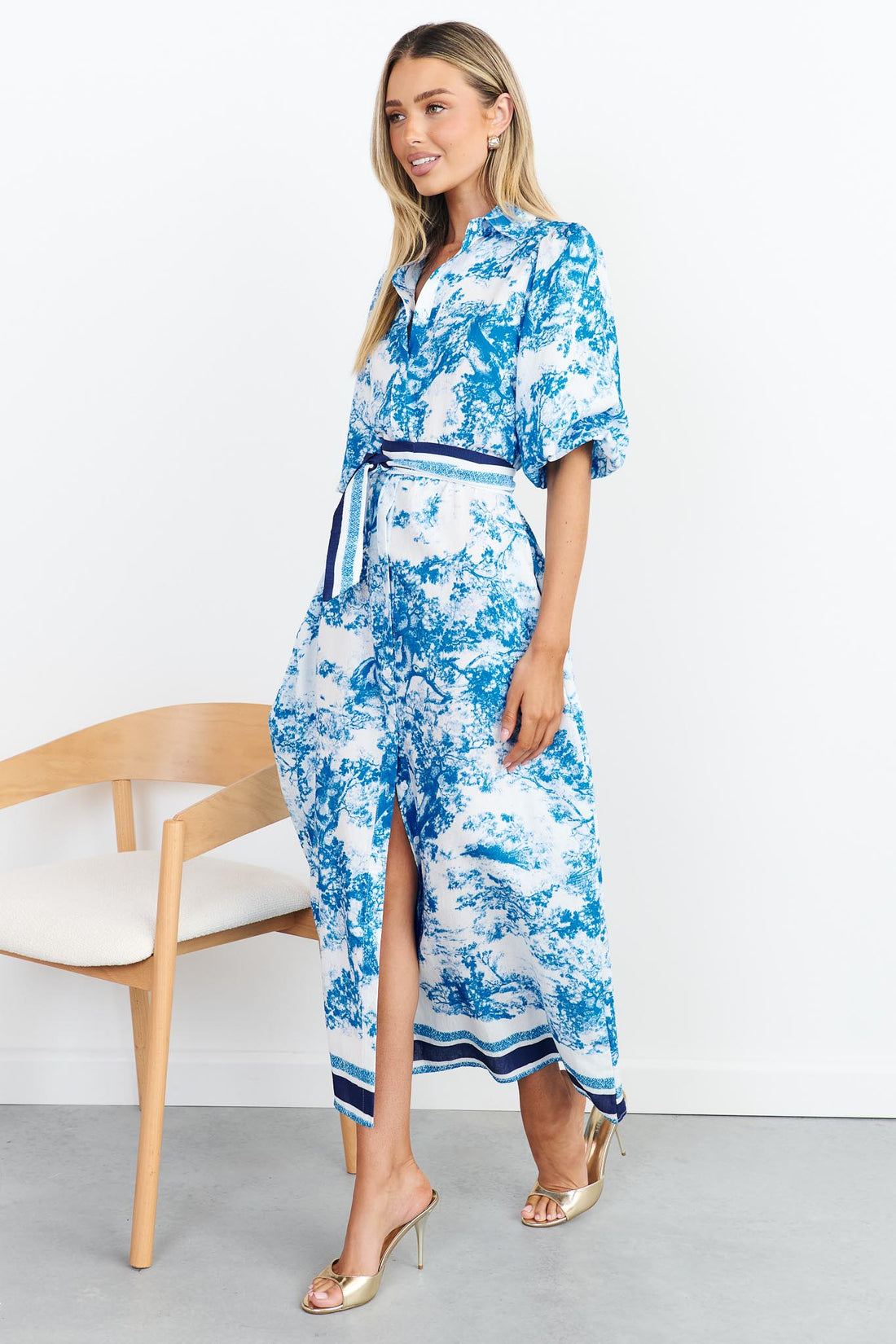 Side view of blue toile print shirt dress with stripe waist tie